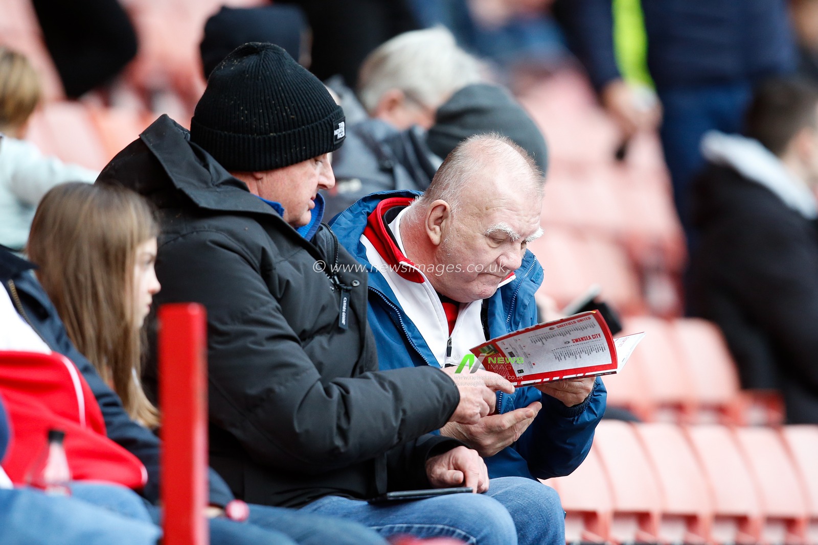 Fans of Sheffield United read the match day programme before the Sky Bet Championship match Sheffield United vs Swansea City at Bramall Lane, Sheffield, United Kingdom, 11th February 2023

(Photo by Ben Early/News Images)