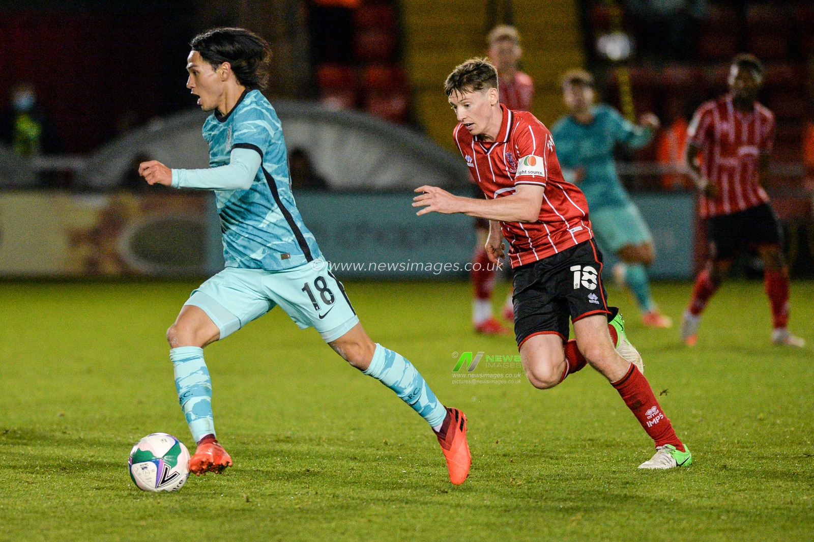 Takumi Minamino (18) of Liverpool in action.