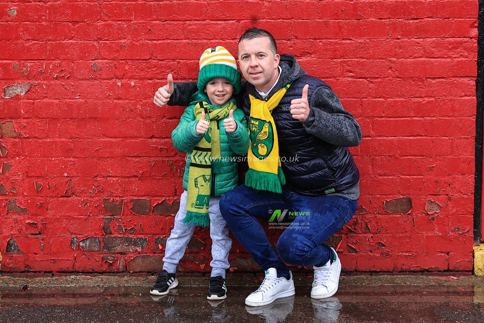 Father and son Norwich fans travel to Oakwell in the pouring rain to welcome the Norwich team coach
