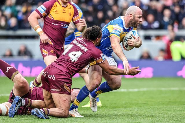 Matt Frawley of Leeds Rhinos is tackled by Ashton Golding of Huddersfield Giants during the Betfred Super League Round 8 match Leeds Rhinos vs Huddersfield Giants at Headingley Stadium, Leeds, United Kingdom, 18th April 2025

(Photo by Alfie Cosgrove/News Images)