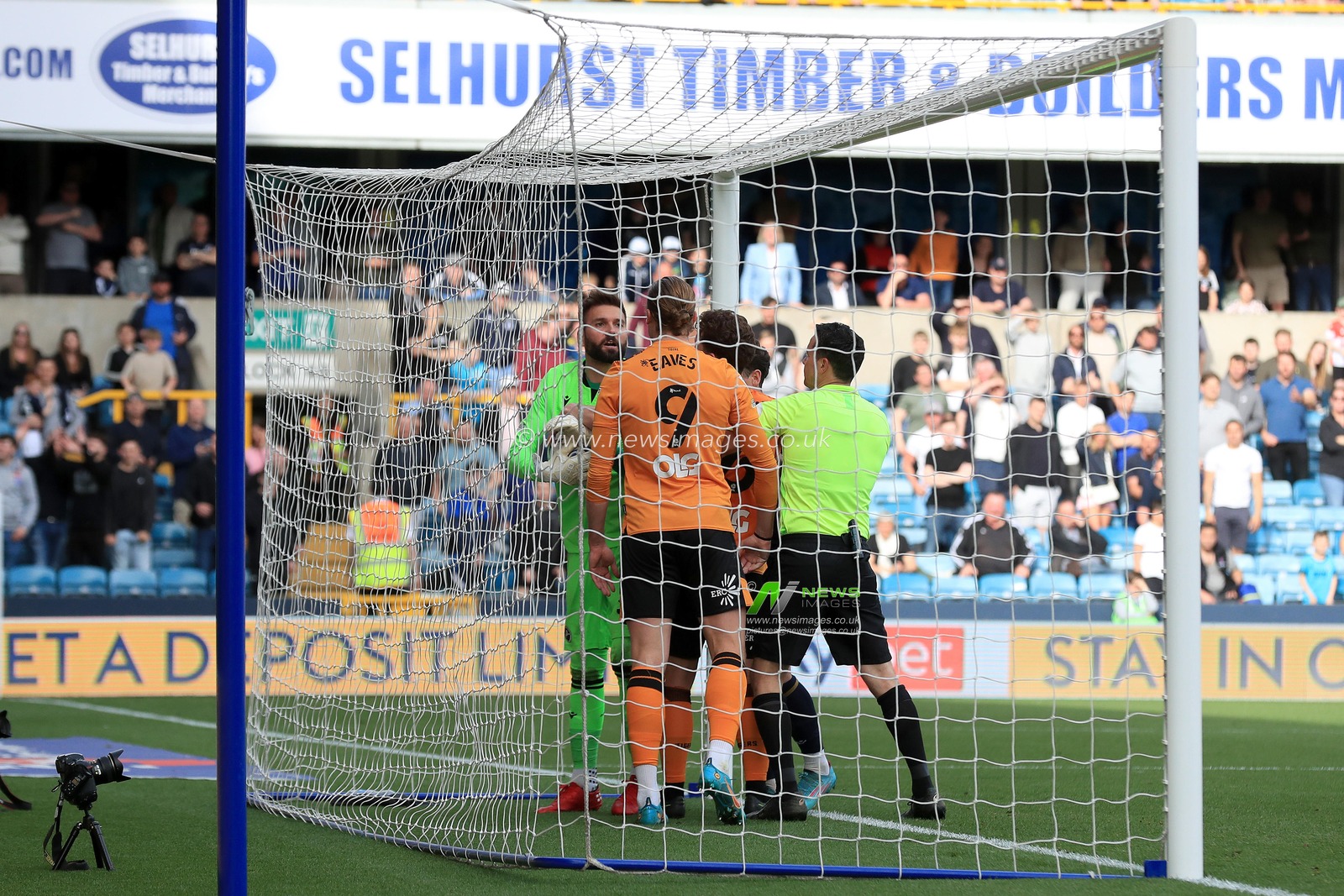 Tom Eaves #9 of Hull City and Bartosz Bia?kowski #33 of Millwall square up as players try to retrieve the ball.