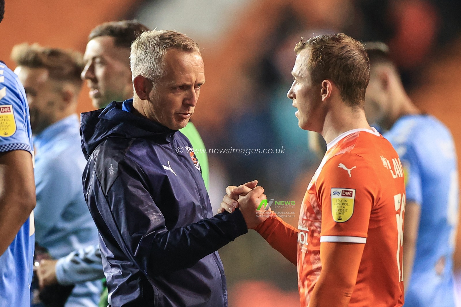 Neil Critchley Head Coach of Blackpool and Shayne Lavery #19 of Blackpool shake hands after the game