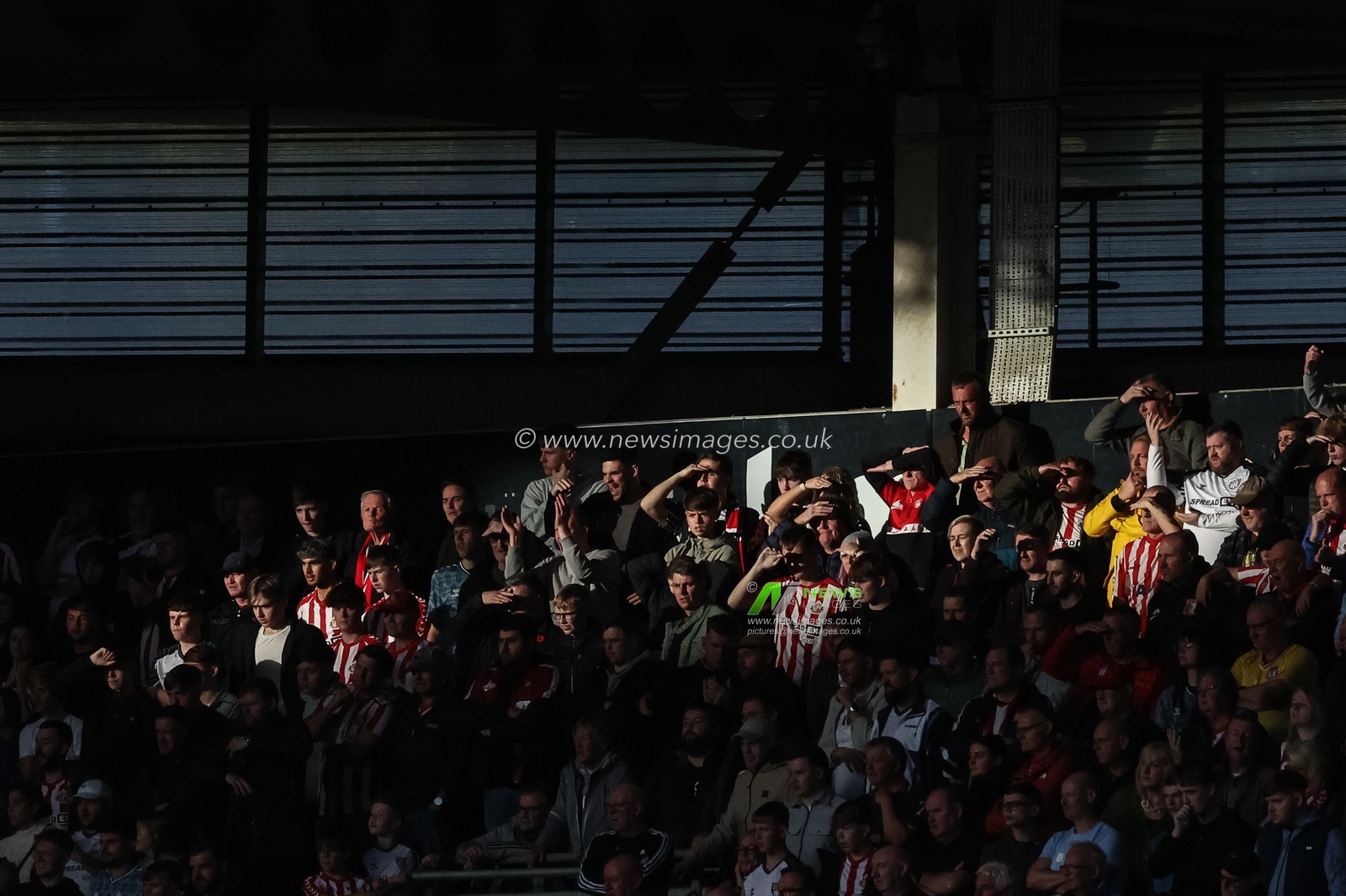 Sunderland fans shield their eyes from the sun as they lead by one goal to nil during the Sky Bet Championship match Hull City vs Sunderland at MKM Stadium, Hull, United Kingdom, 20th October 2024

(Photo by Mark Cosgrove/News Images)