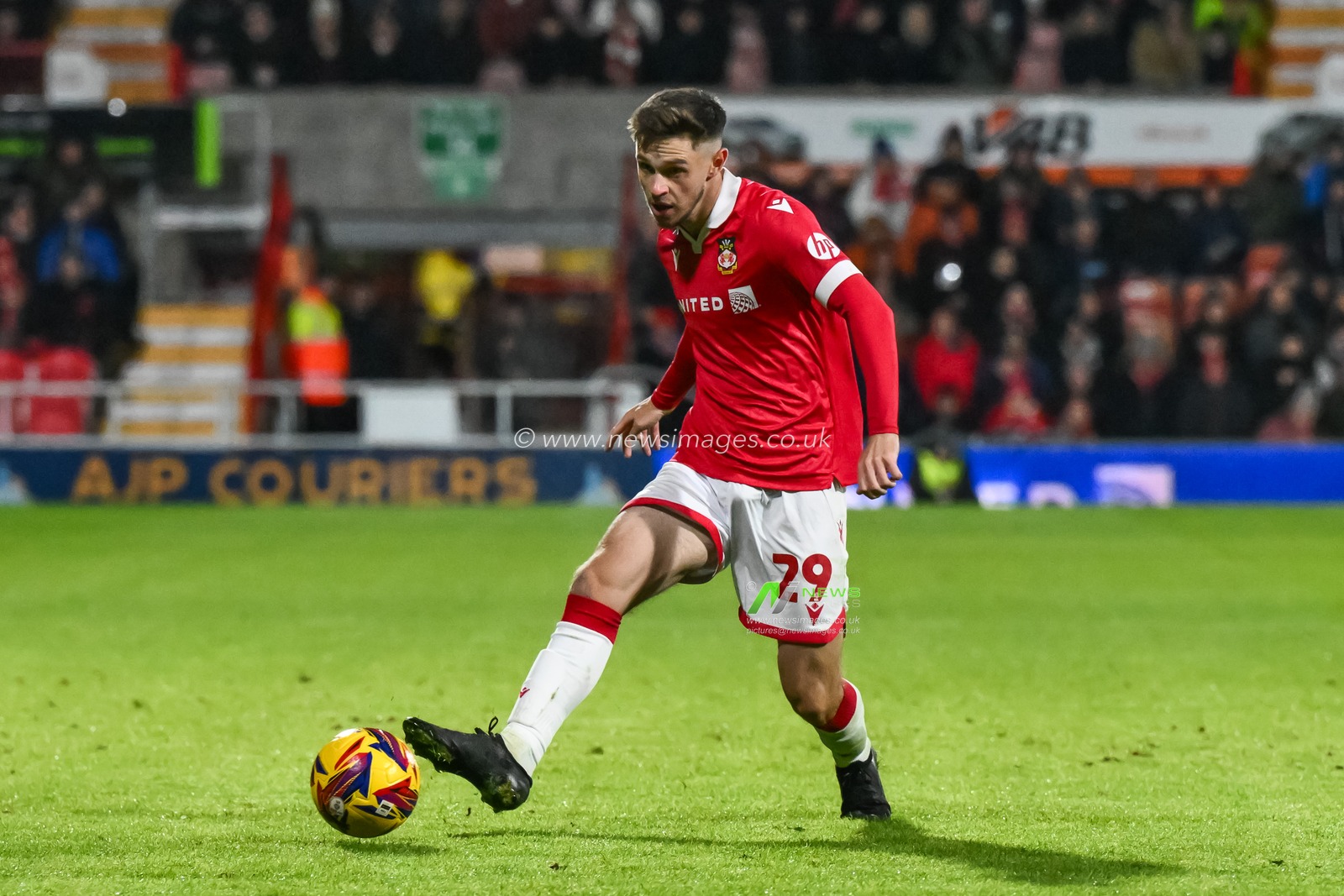 Ryan Barnett of Wrexham passes the ball during the Sky Bet League 1 match Wrexham vs Barnsley at SToK Cae Ras, Wrexham, United Kingdom, 3rd December 2024

(Photo by Craig Thomas/News Images)