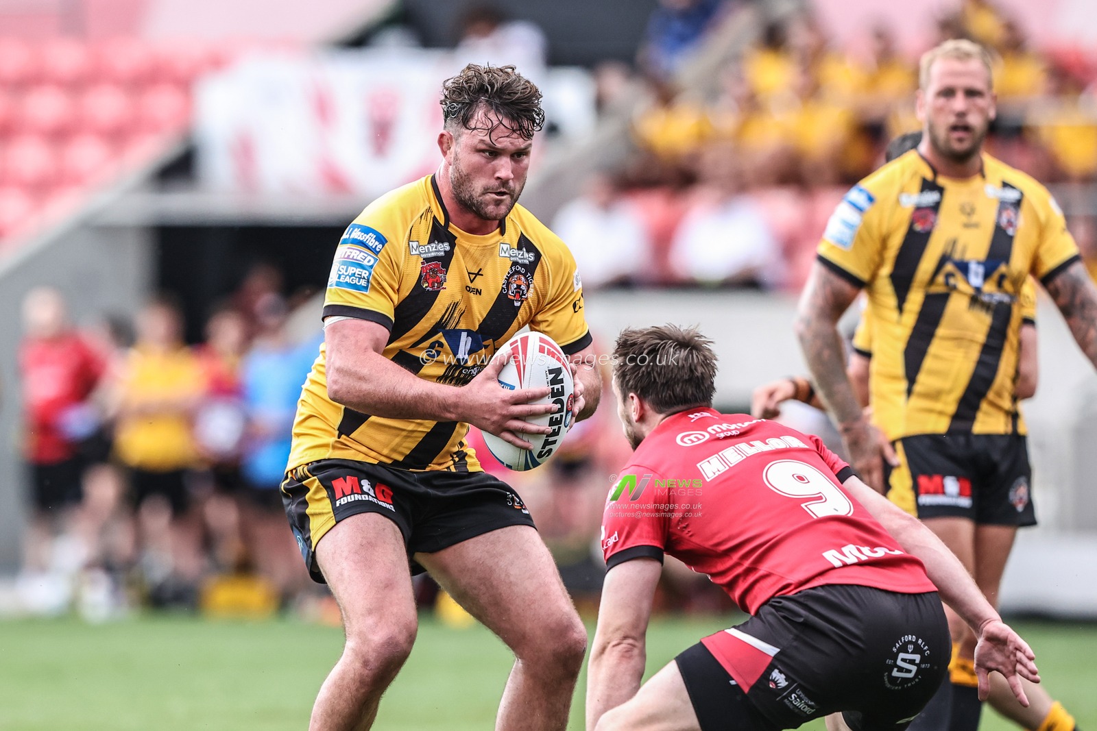 Bradley Singleton of Castleford Tigers is tackled during the Betfred Super League Round 18 match Salford Red Devils vs Castleford Tigers at Salford Community Stadium, Eccles, United Kingdom, 13th July 2025

(Photo by Alfie Cosgrove/News Images)