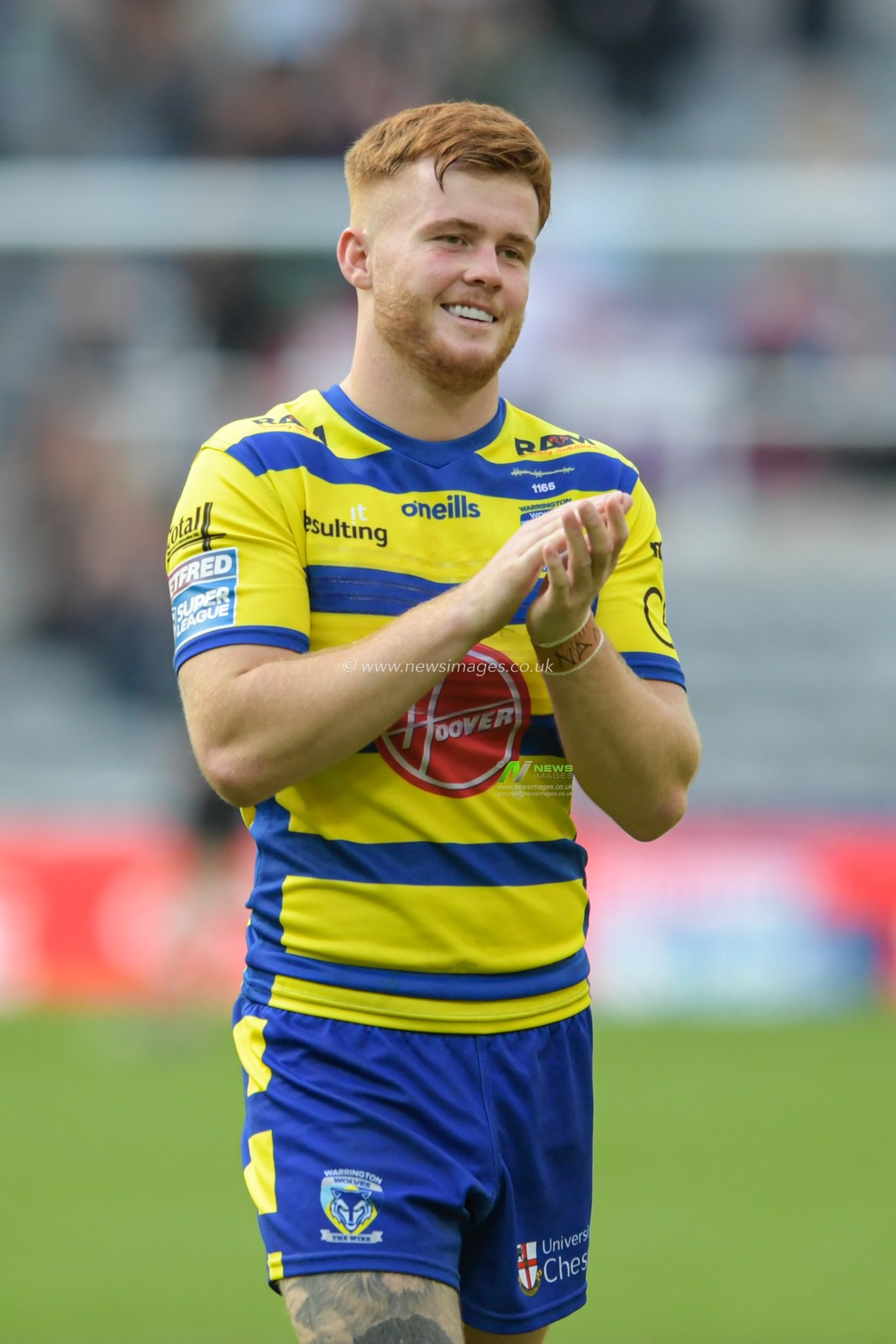 Ellis Longstaff (26) of Warrington Wolves applauds the travelling supporters at the end of the game after beating Wigan Warriors 6-10