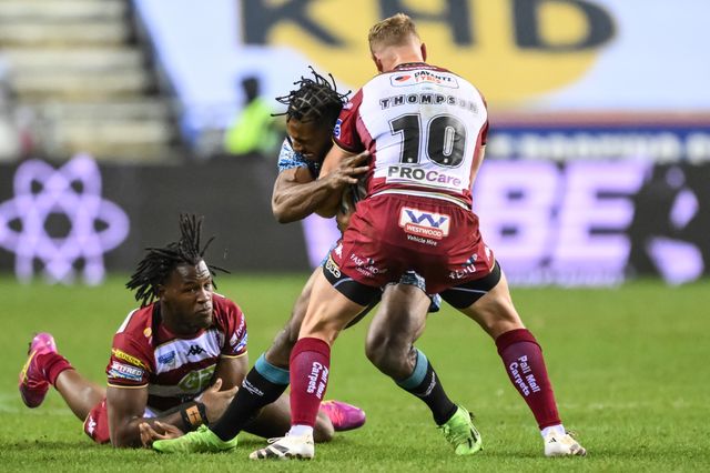 Edwin Ipape of Leigh Leopards is tackled by Junior Nsemba and Luke Thompson of Wigan Warriors s during the Betfred Super League Round 1 match Wigan Warriors vs Leigh Leopards at The Brick Community Stadium, Wigan, United Kingdom, 13th February 2025

(Photo by Craig Thomas/News Images)