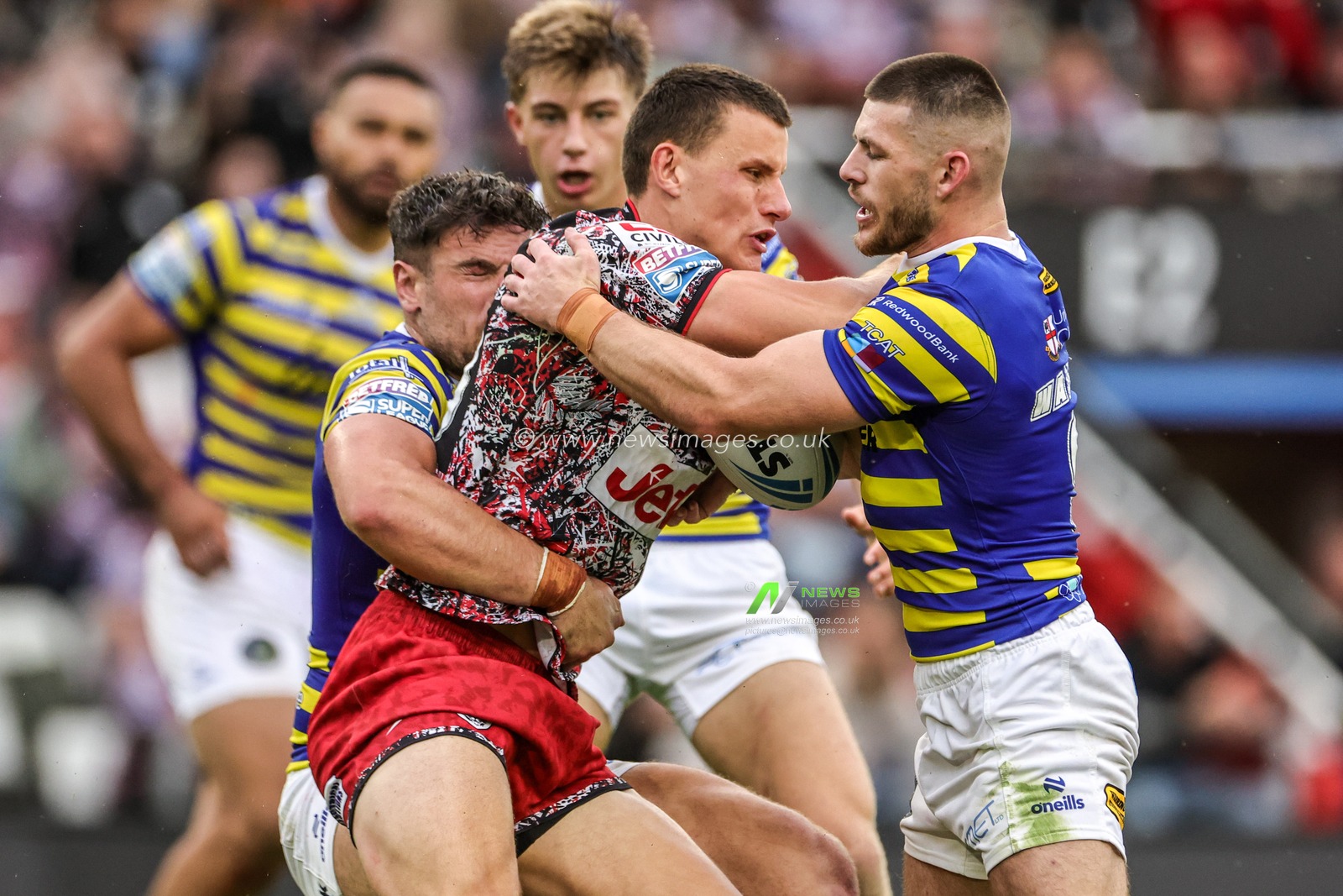 Innes Senior of Leigh Leopards is tackled by Danny Walker of Warrington Wolves and Joe Philbin of Warrington Wolves during the Betfred Super League round 20 match Leigh Leopards vs Warrington Wolves at Leigh Sports Village, Leigh, United Kingdom on 25 July 2026

(Photo by Alfie Cosgrove/News Images)