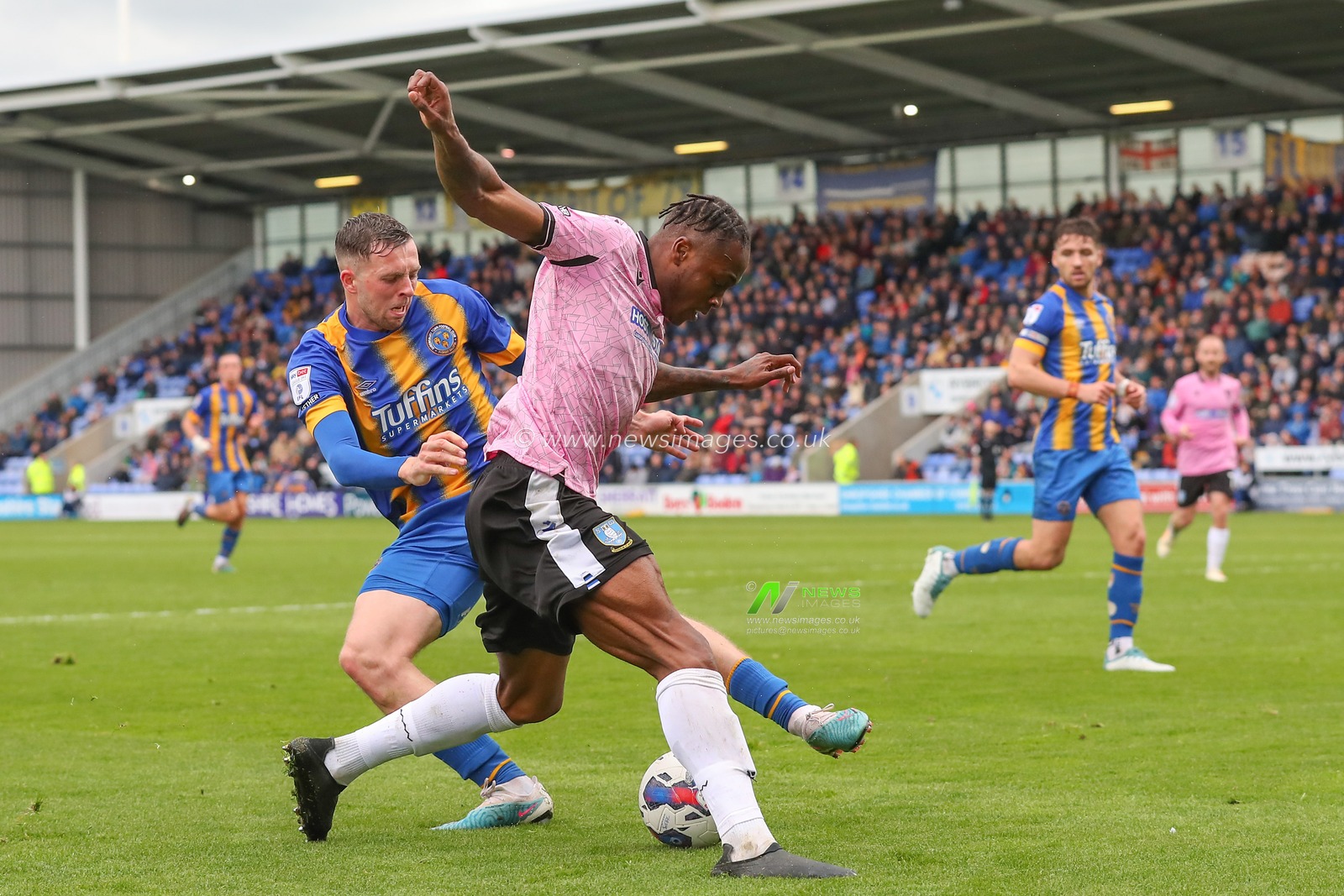 Jordan Shipley #26 of Shrewsbury Town tackles Dennis Adeniran #8 of Sheffield Wednesday during the Sky Bet League 1 match Shrewsbury Town vs Sheffield Wednesday at Greenhous Meadow, Shrewsbury, United Kingdom, 29th April 2023

(Photo by Gareth Evans/News Images)