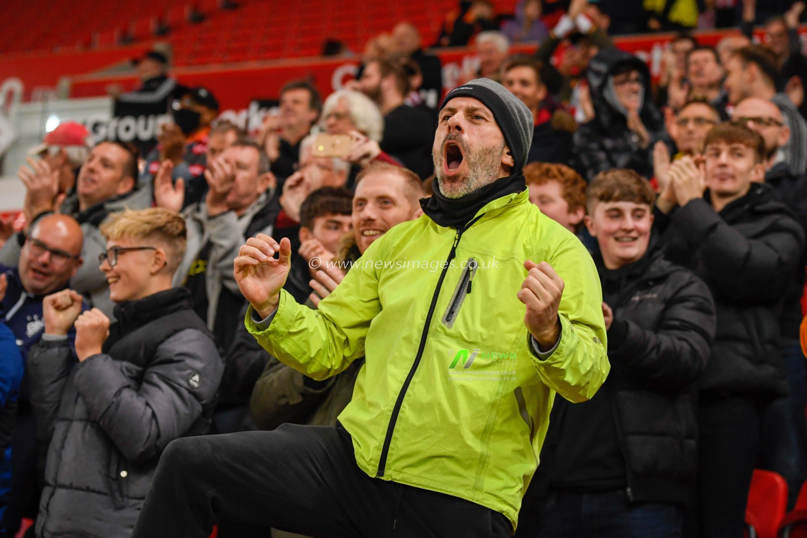 The Brentford fans celebrate their team scoring a goal to make it 0-1