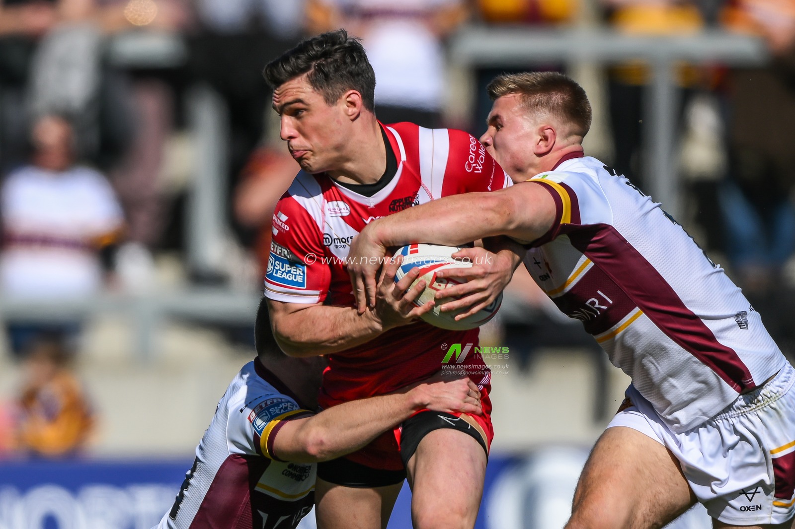 Brodie Croft #6 of Salford Red Devils is tackled by Olly Russell #23 and Harry Rushton #16 of Huddersfield Giants during the Betfred Super League Round 7 match Salford Red Devils vs Huddersfield Giants at AJ Bell Stadium, Eccles, United Kingdom, 2nd April 2023

(Photo by Craig Thomas/News Images)