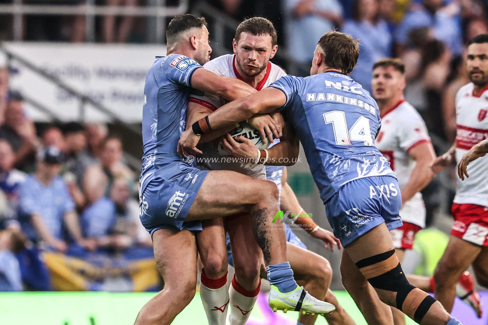 James Batchelor of Hull KR is tackled by Chris Hankinson of Leeds Rhinos and Jake Connor of Leeds Rhinos during the Betfred Super League round 16 match Leeds Rhinos vs Hull KR at AMT Headingley Stadium, Leeds, United Kingdom on 26 June 2026

(Photo by Alfie Cosgrove/News Images)