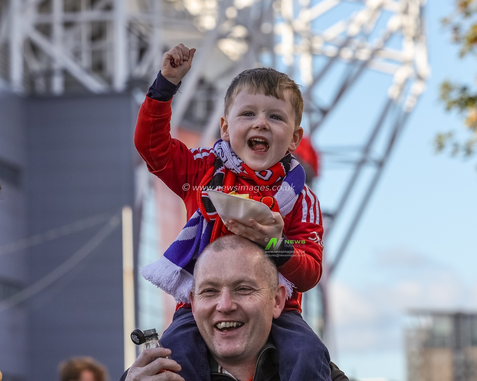 A young Manchester United fan on his dads shoulders eating a tray of chips during the Premier League match Manchester United vs Brighton and Hove Albion at Old Trafford, Manchester, United Kingdom, 25th October 2025

(Photo by Mark Cosgrove/News Images)