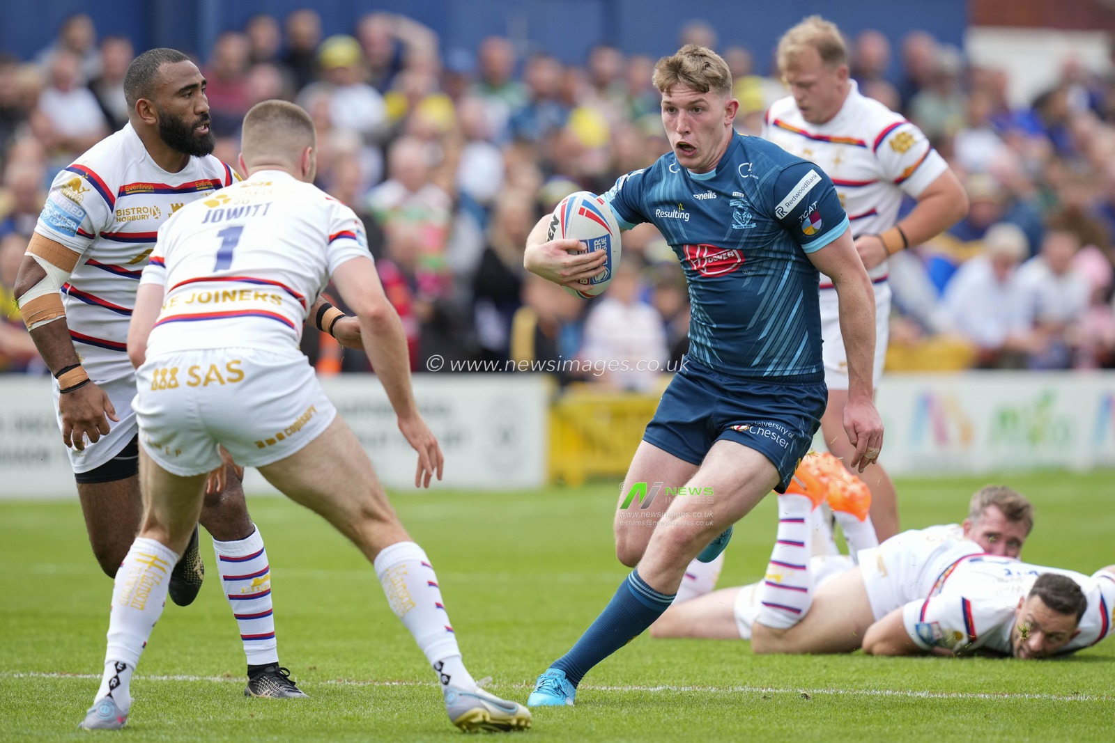 Matty Nicholson #12 of Warrington Wolves runs at Max Jowitt #1 of Wakefield Trinity during the Betfred Super League Round 20 match Wakefield Trinity vs Warrington Wolves at The Be Well Support Stadium, Wakefield, United Kingdom, 30th July 2023

(Photo by Steve Flynn/News Images)