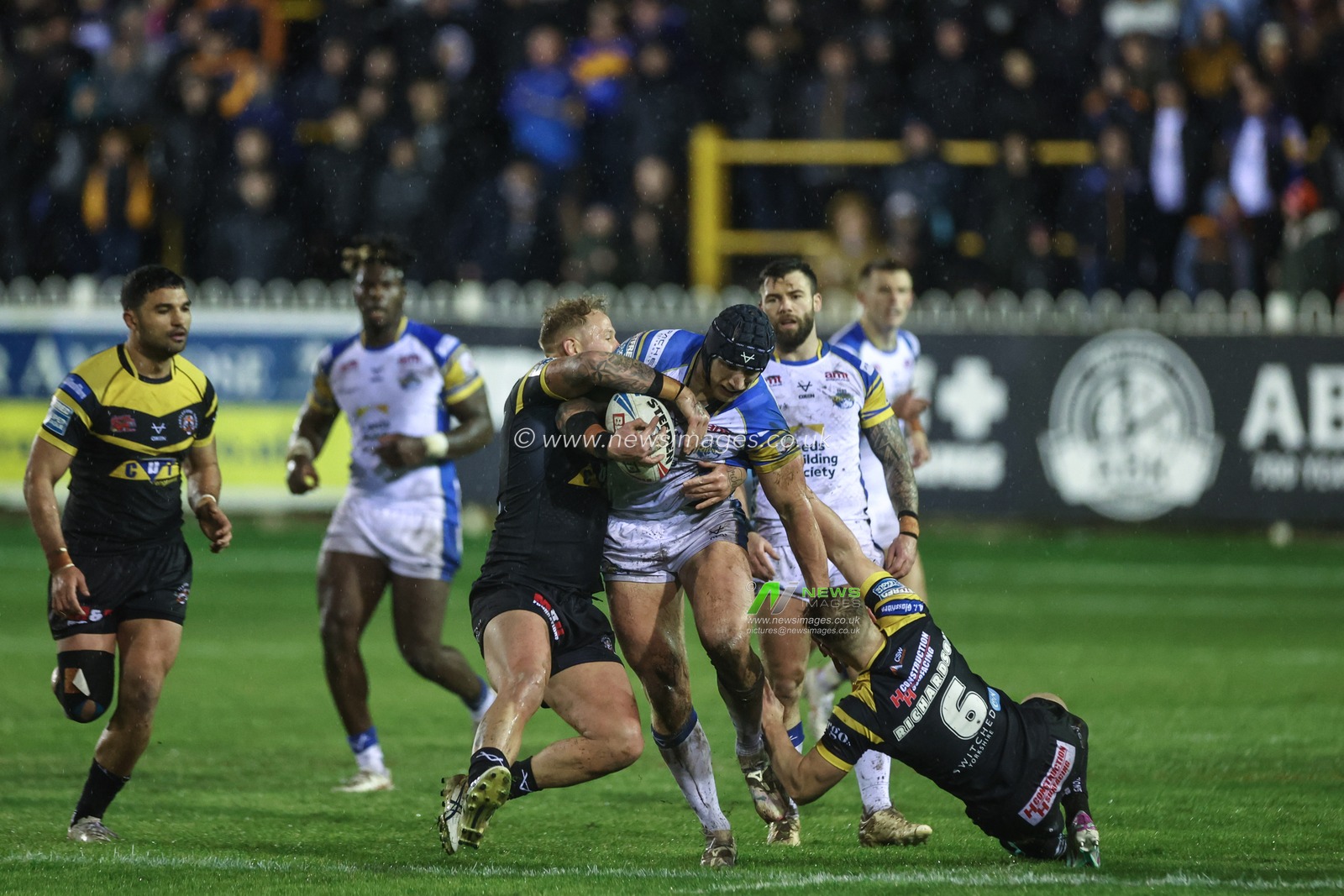 Mikolaj Oledzki of Leeds Rhinos is tackled by Joe Westerman of Castleford Tigers and Danny Richardson of Castleford Tigers during the Betfred Super League Round 6 match Castleford Tigers vs Leeds Rhinos at The Mend-A-Hose Jungle, Castleford, United Kingdom, 28th March 2024

(Photo by Mark Cosgrove/News Images)