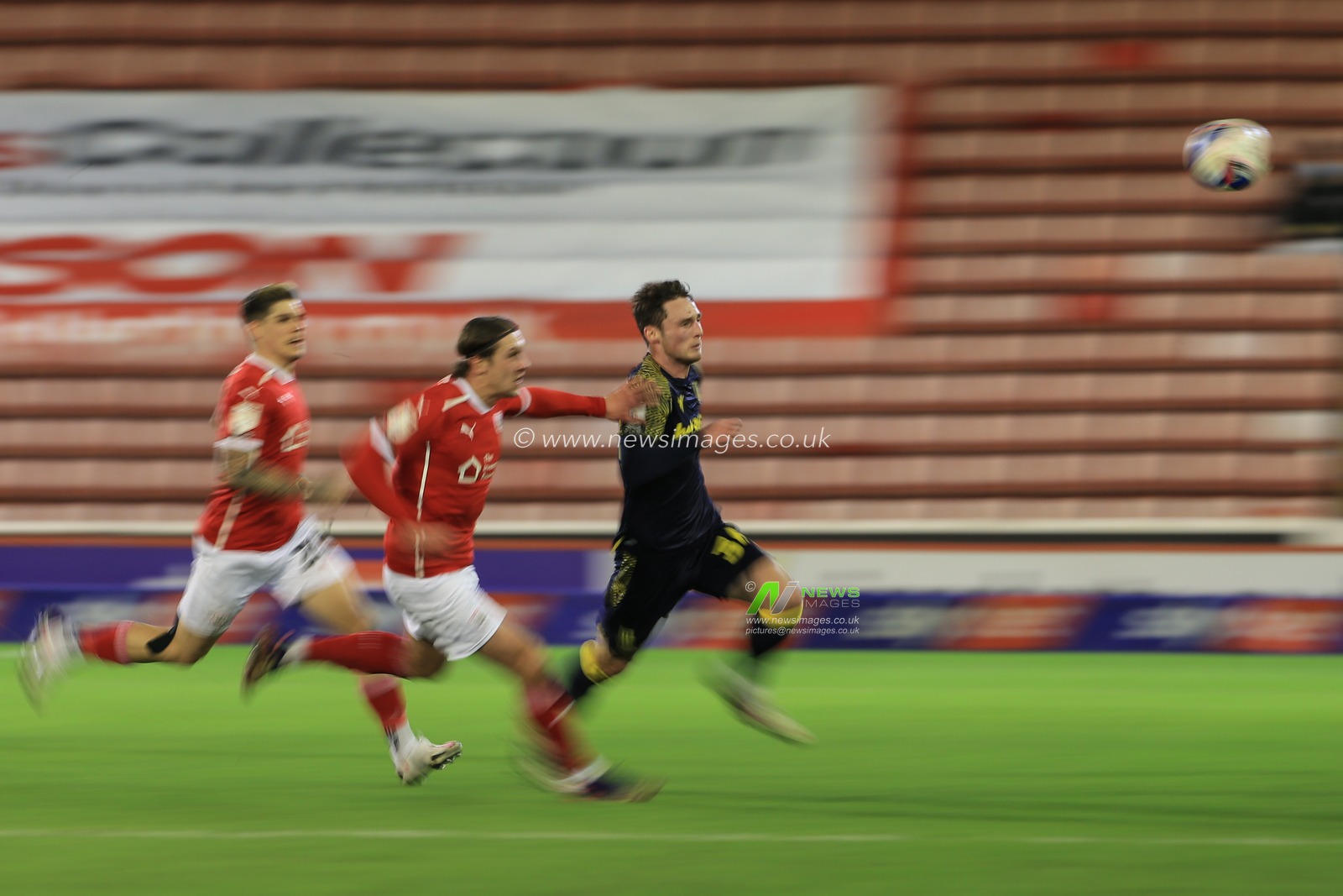 Jordan Thompson #34 of Stoke City chases the ball as Callum Brittain #7 of Barnsley tracks him closely