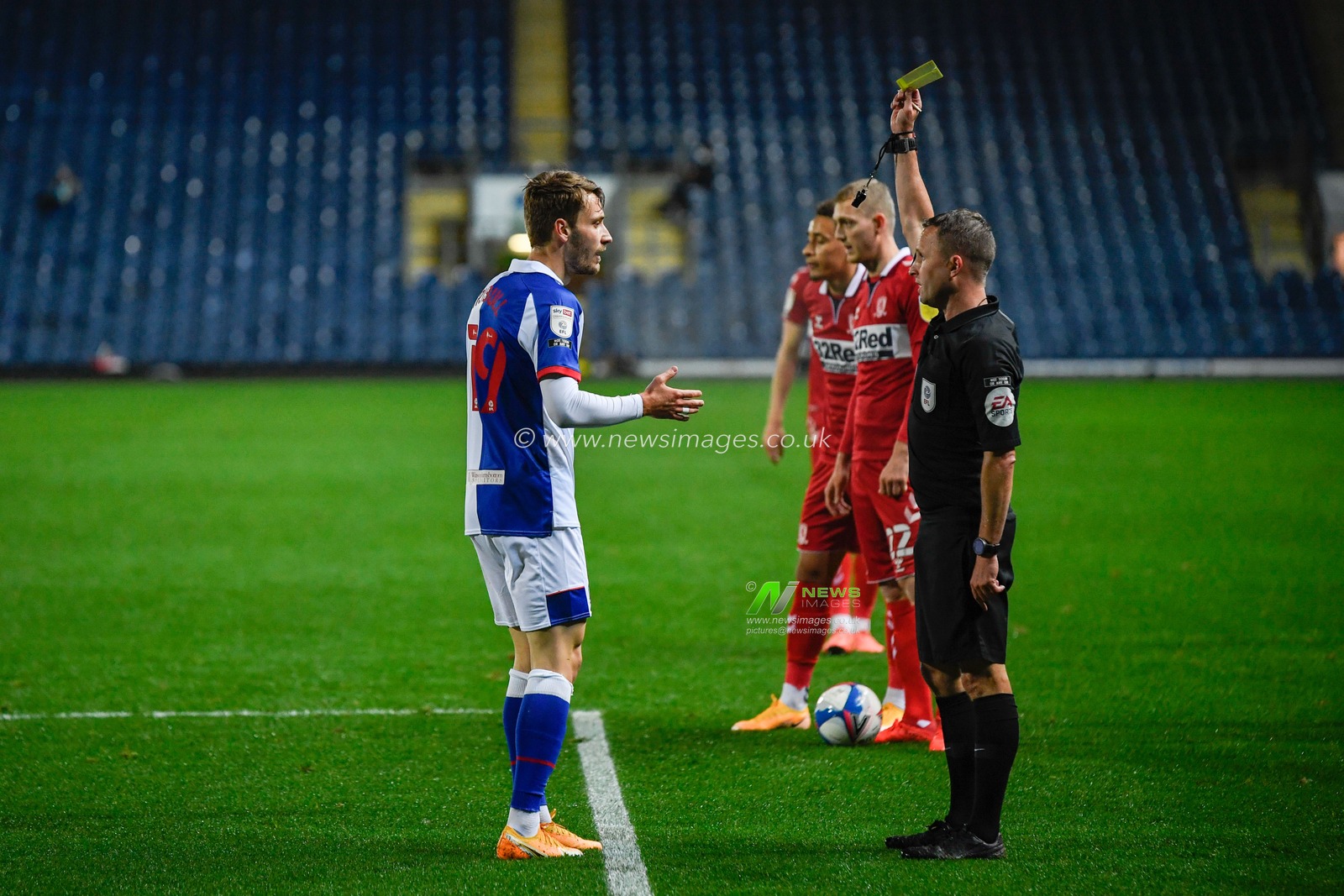 Tom Trybull (19) of Blackburn Rovers is shown a yellow card