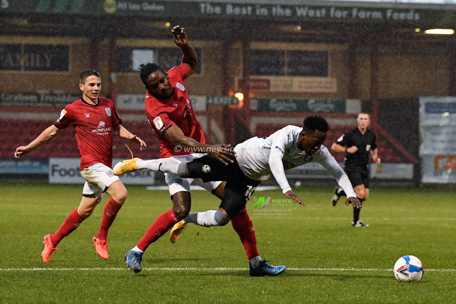 Siriki Dembele #10 of Peterborough United falls under pressure from Omar Beckles #29 of Crewe Alexandra