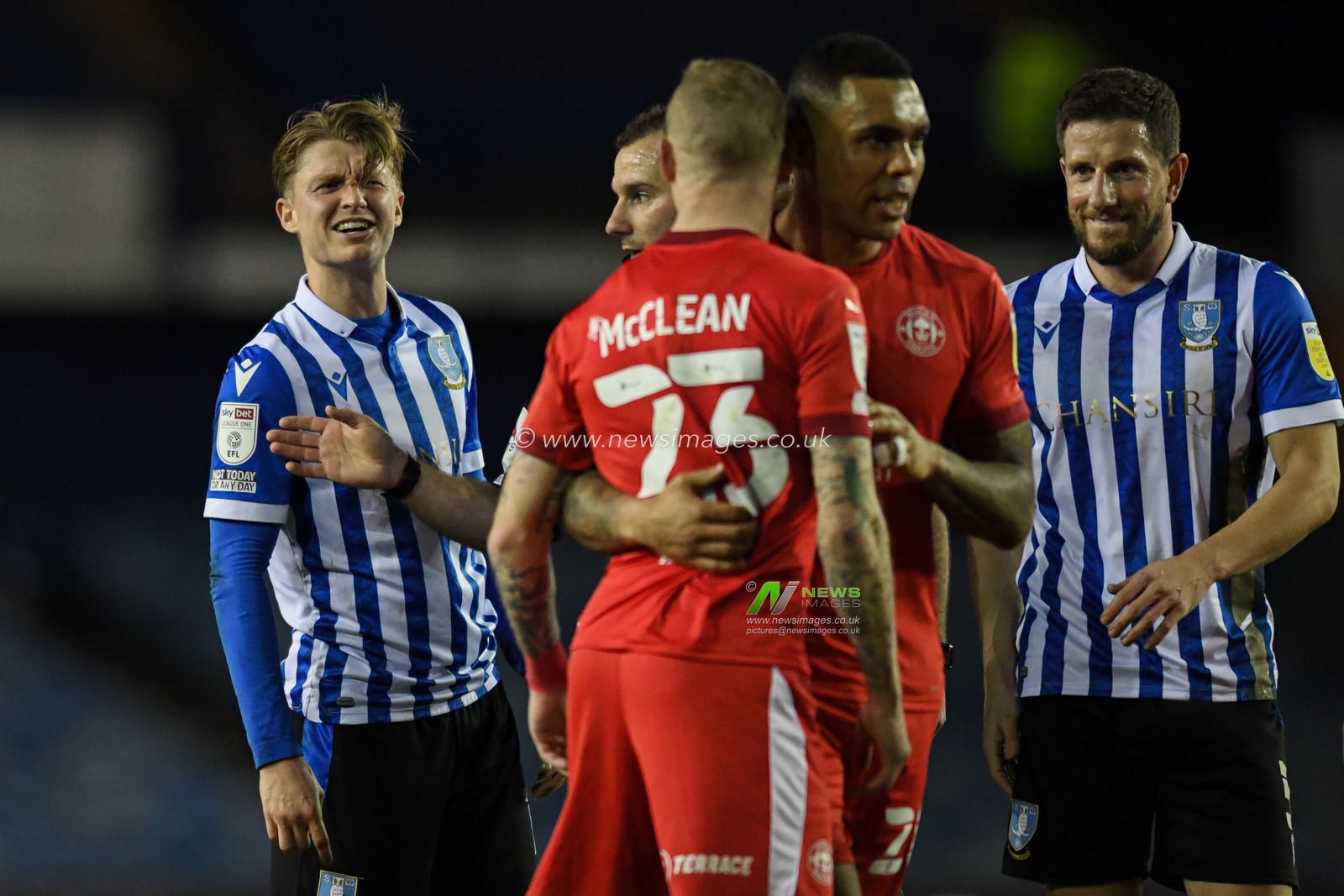 George Byers #14 of Sheffield Wednesday and James McClean #23 of Wigan Athletic exchange words during the game
