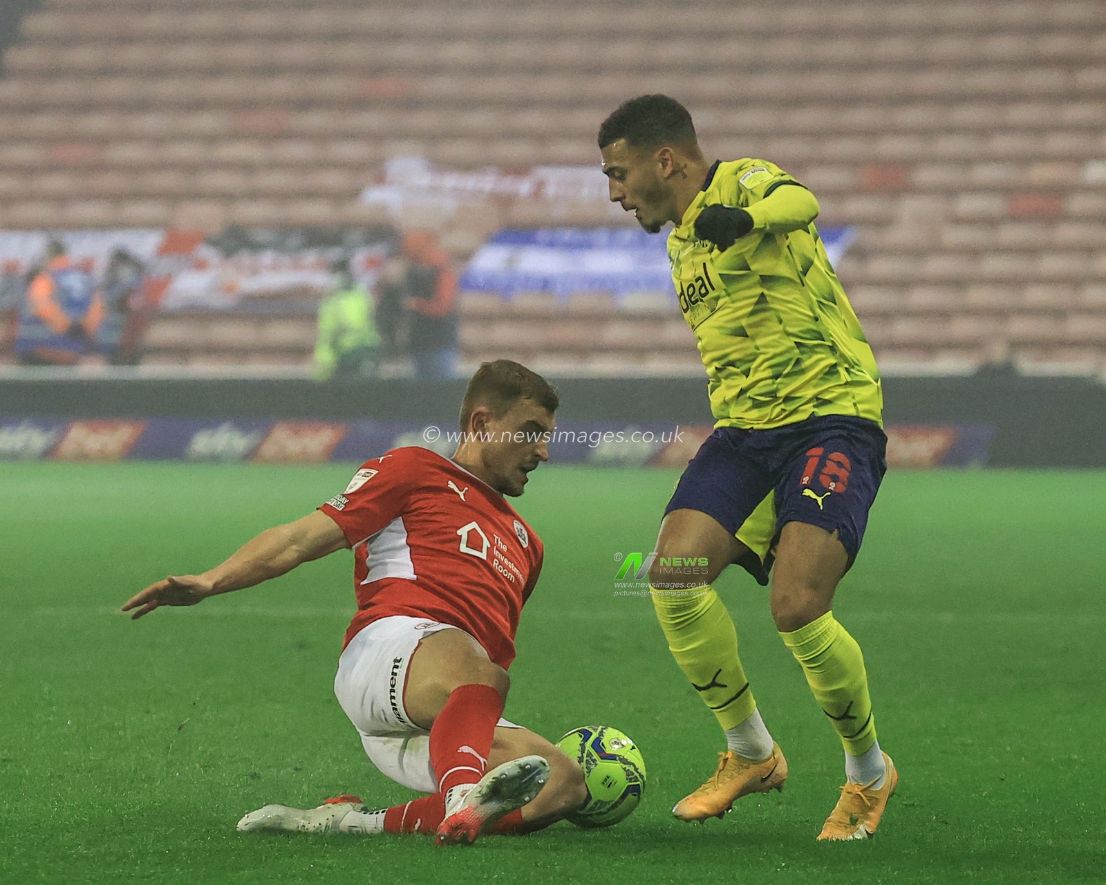 MichaÅ‚ Helik #30 of Barnsley slides in to win the ball from Karlan Grant #18 of West Bromwich Albion