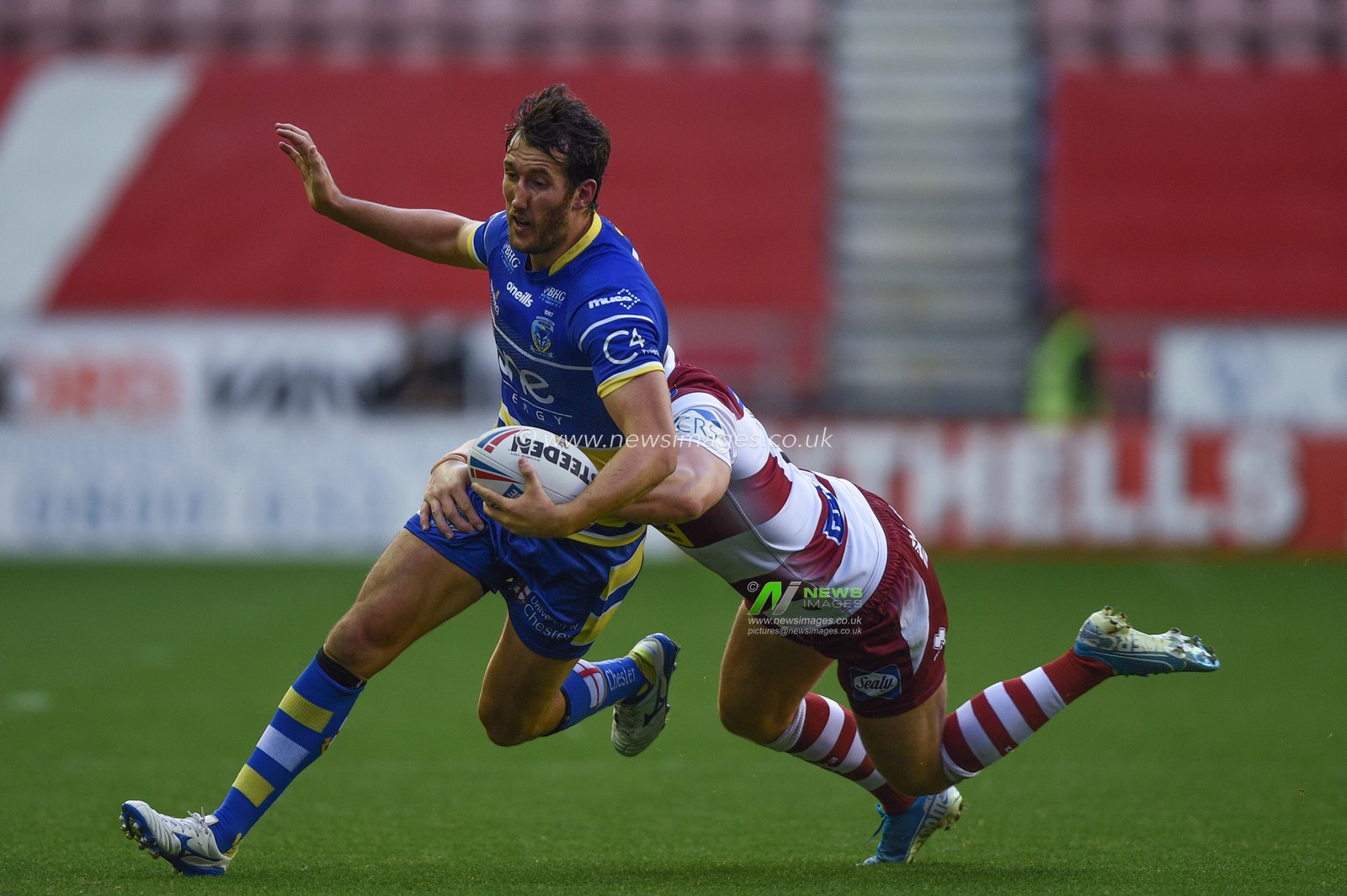 16th August 2019 , DW Stadium, Wigan, England;  Betfred Super League, Round 26, Wigan Warriors vs Warrington Wolves ; Stefan Ratchford of Warrington Wolves is tackled by George Williams (6) of Wigan Warriors 

Credit: Richard Long/News Images