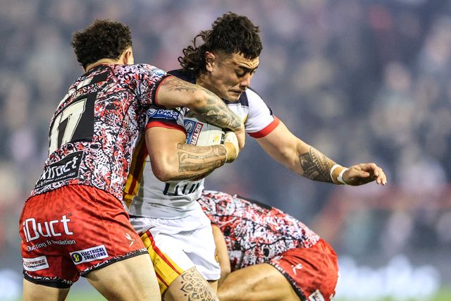 Charlie Staines of Catalans Dragons is tackled by Liam Horne of Leigh Leopards and Adam Cook of Leigh Leopards during the Betfred Super League match Leigh Leopards vs Catalans Dragons at Leigh Sports Village, Leigh, United Kingdom on 06 March 2026

(Photo by Alfie Cosgrove/News Images)