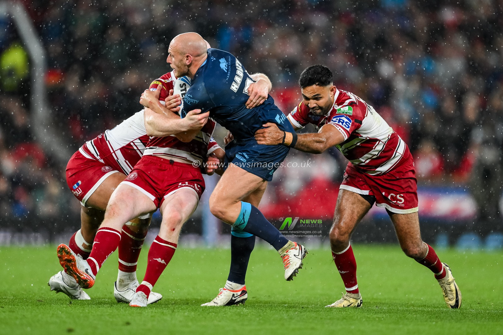Dean Hadley of Hull KR is tackled by Liam Farrell and Bevan French of Wigan Warriors during the Betfred Super League Grand Final match Wigan Warriors vs Hull KR at Old Trafford, Manchester, United Kingdom, 12th October 2024

(Photo by Craig Thomas/News Images)