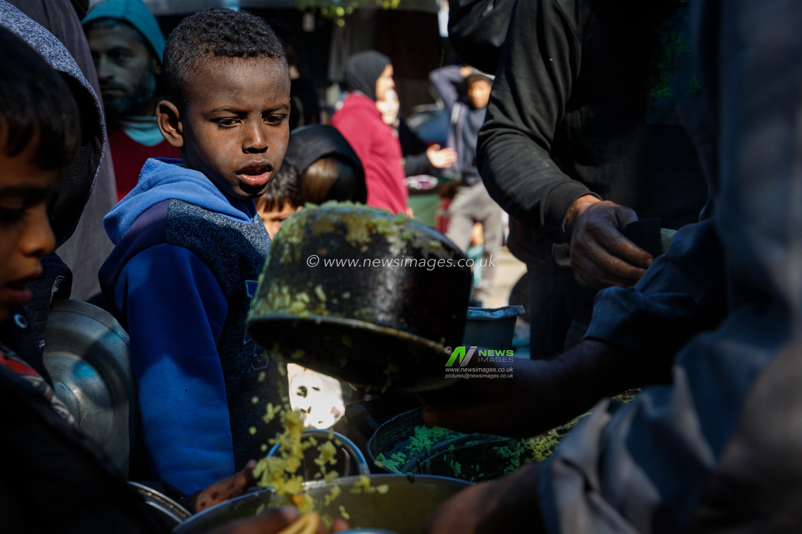 Palestinians try to get a free meal (from a charity restaurant) in a temporary displacement camp after the decision to close the American World Kitchen for the second day in a row, which exacerbated the plight of displaced Palestinians in the southern Gaza Strip, on December 2, 2024.(Photo: Mohammed Skaik/News Images)