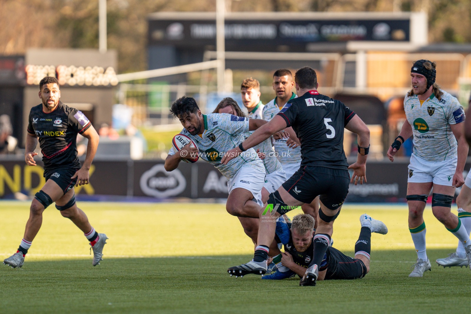 Ahsee Tuala #11 of Northampton Saints tries to break through the tackle