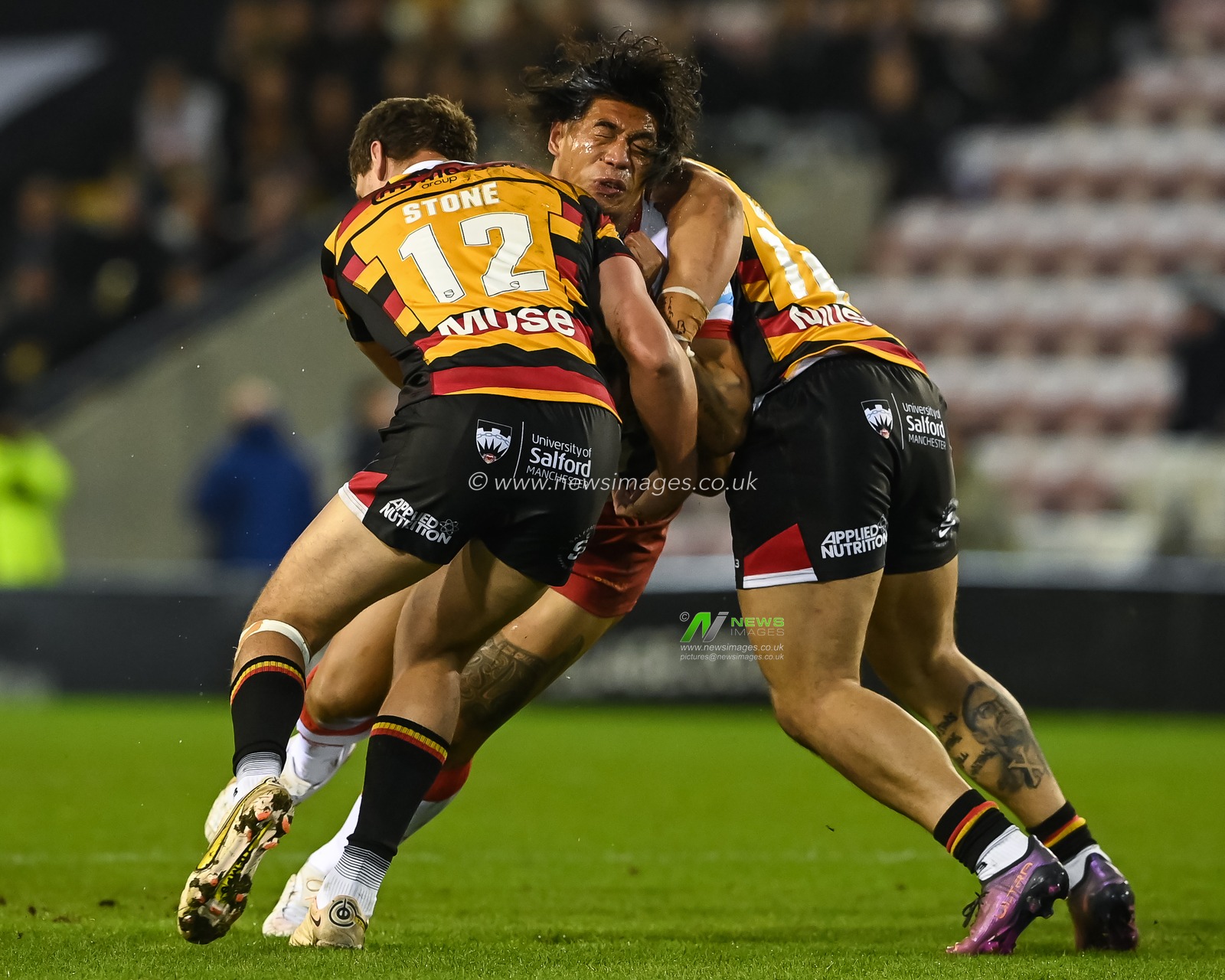 Tom Amone #8 of Leigh Leopards is tackled by James Greenwood #12 and Ryan Lannon #16 of Salford Red Devils during the Betfred Super League Round 1 match Leigh Leopards vs Salford Red Devils at Leigh Sports Village, Leigh, United Kingdom, 17th February 2023

(Photo by Craig Thomas/News Images)