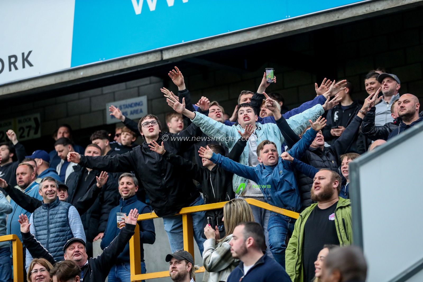 Millwall fans celebrates the team's third goal to make the score during the Sky Bet Championship match Millwall vs Norwich City at The Den, London, United Kingdom, 21st April 2025

(Photo by Izzy Poles/News Images)