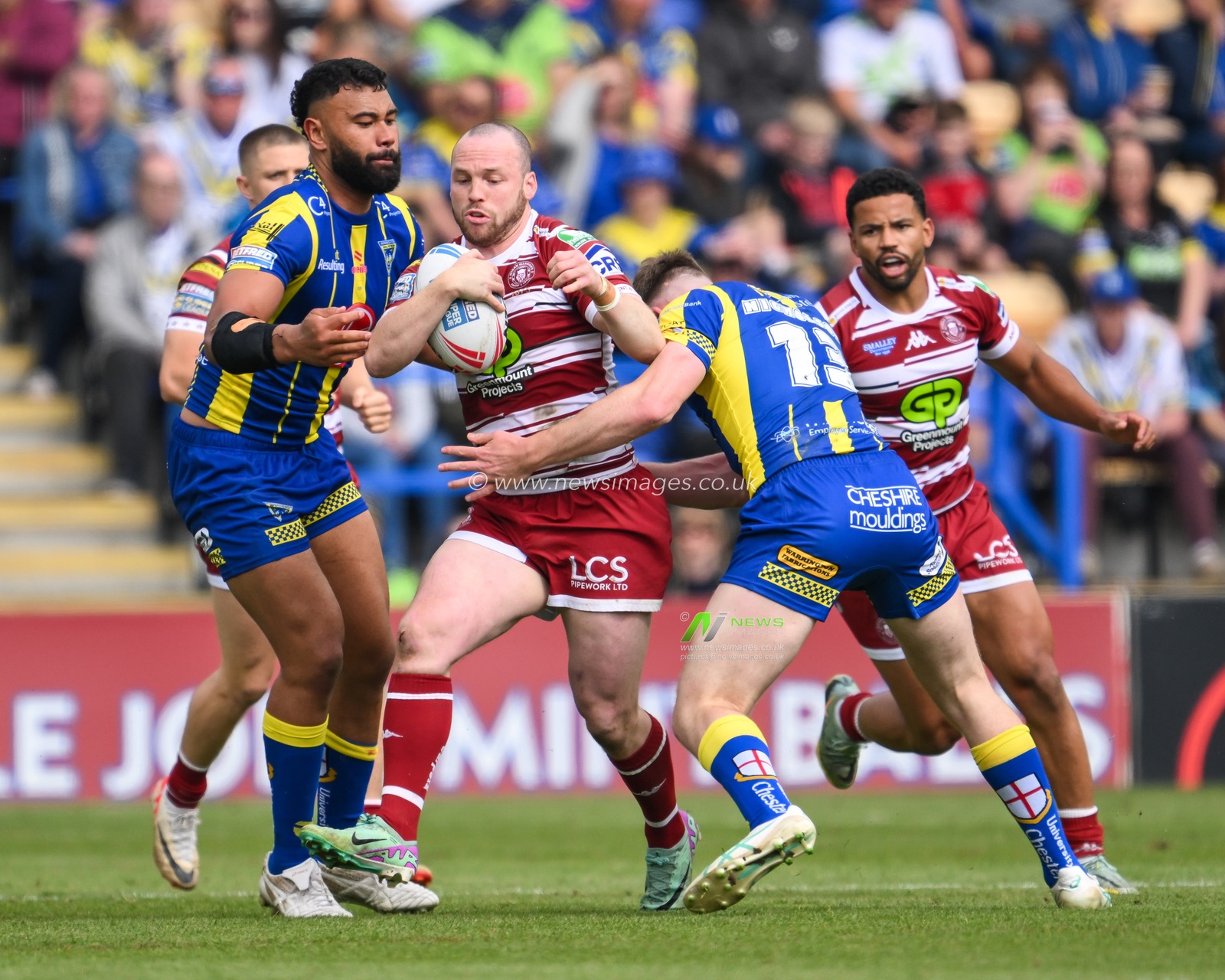 Liam Marshall of Wigan Warriors is tackled by Matty Nicholson of Warrington Wolves during the Betfred Super League Round 13 match Warrington Wolves vs Wigan Warriors at Halliwell Jones Stadium, Warrington, United Kingdom, 1st June 2024

(Photo by Craig Thomas/News Images)