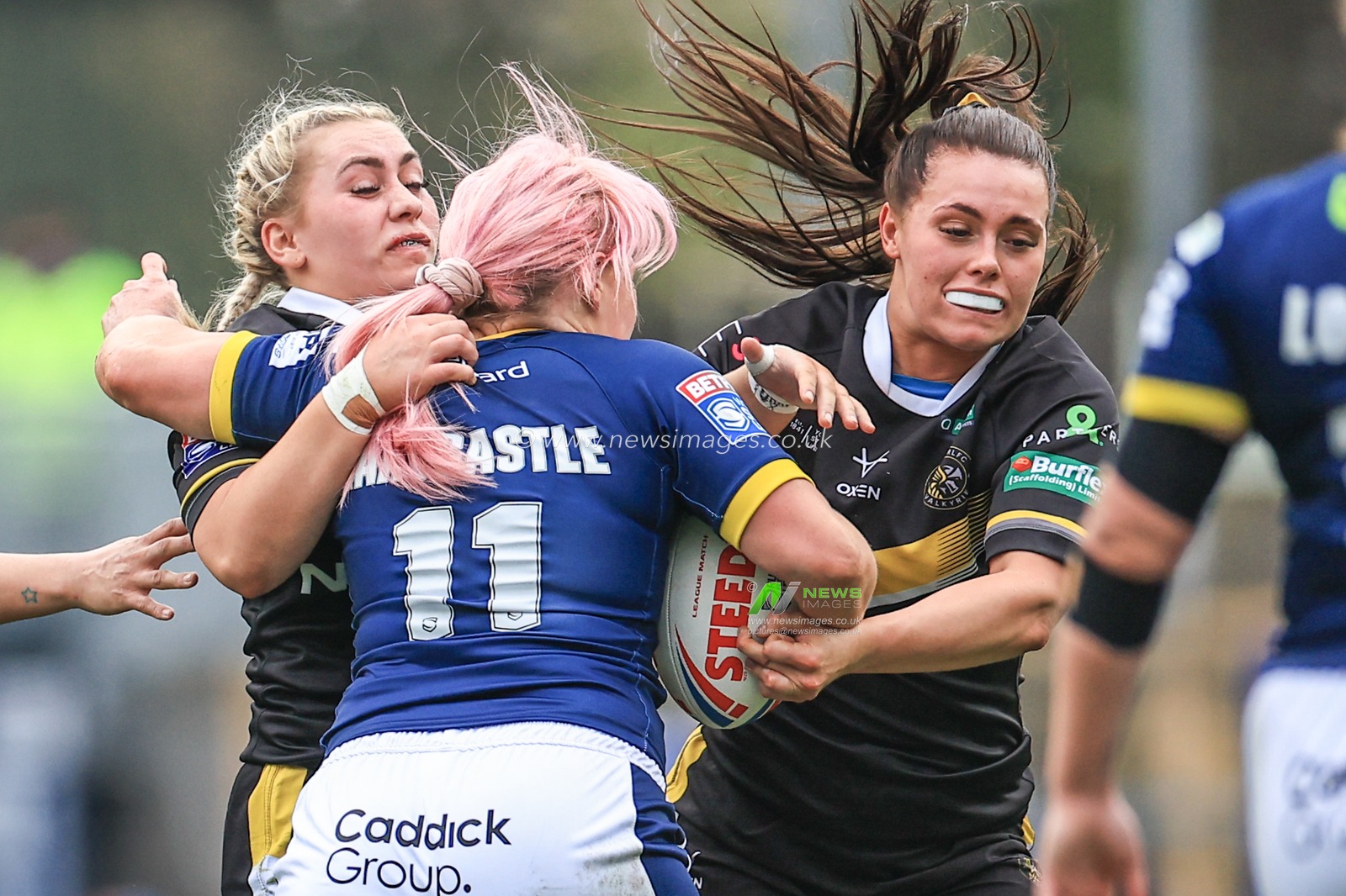 Amy Hardcastle of Leeds Rhinos is tackled by Lacey Owen of York Valkyrie and Sinead Peach of York Valkyrie during the Betfred Women's Super League match Leeds Rhinos vs York Valkyrie at Headingley Stadium, Leeds, United Kingdom, 9th April 2023

(Photo by Mark Cosgrove/News Images)