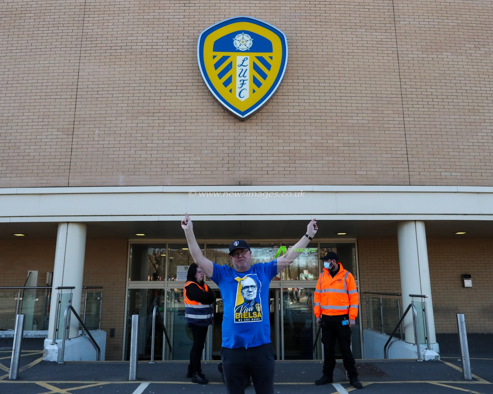 A Leeds United supporter holds up his arms while wearing a Marcelo Bielsa shirt outside Elland Road Stadium in support of Marcelo Bielsa after he was sacked by the club this morning