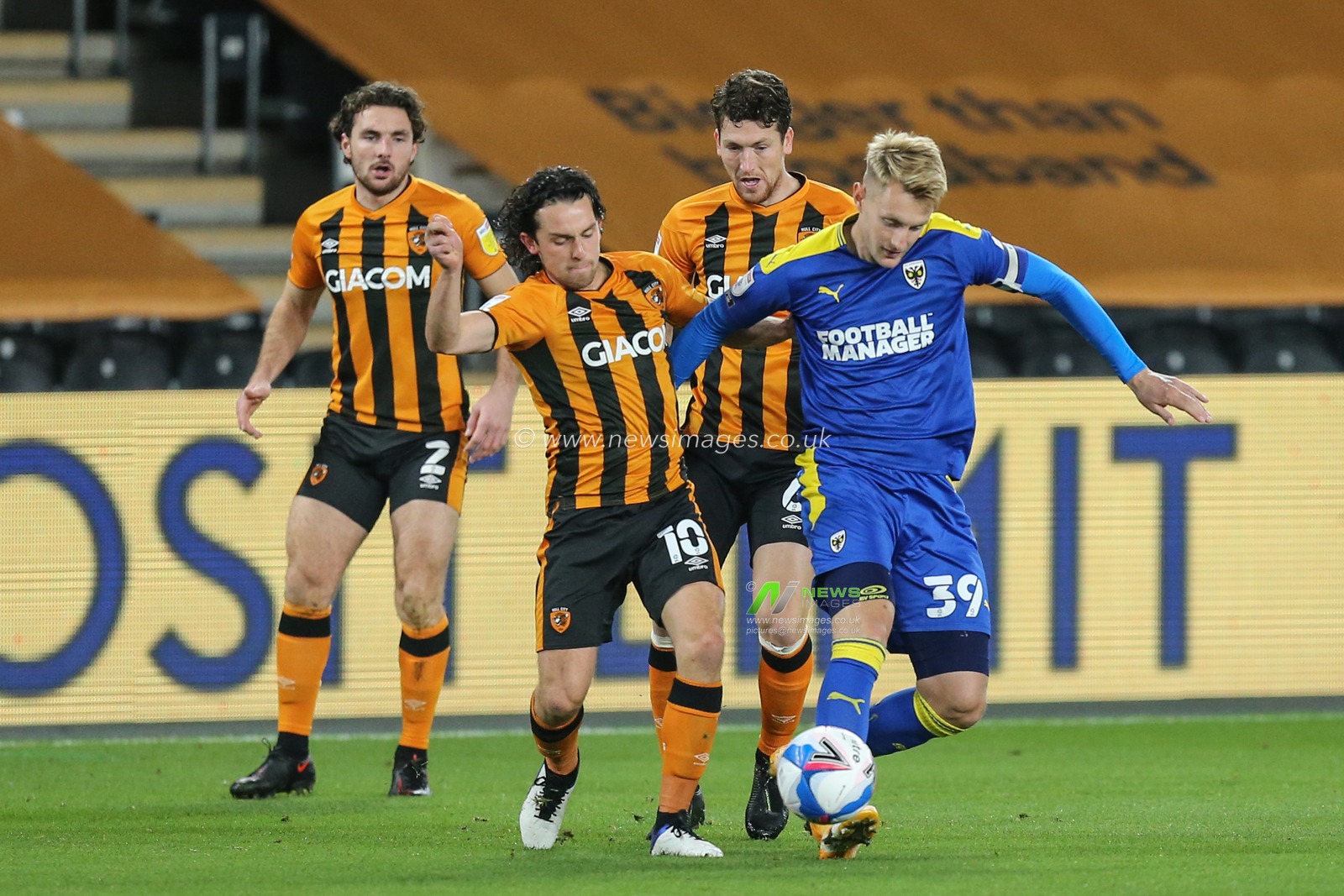 George Honeyman (10) of Hull City and Joe Pigott (39) of AFC Wimbledon challenge for the ball