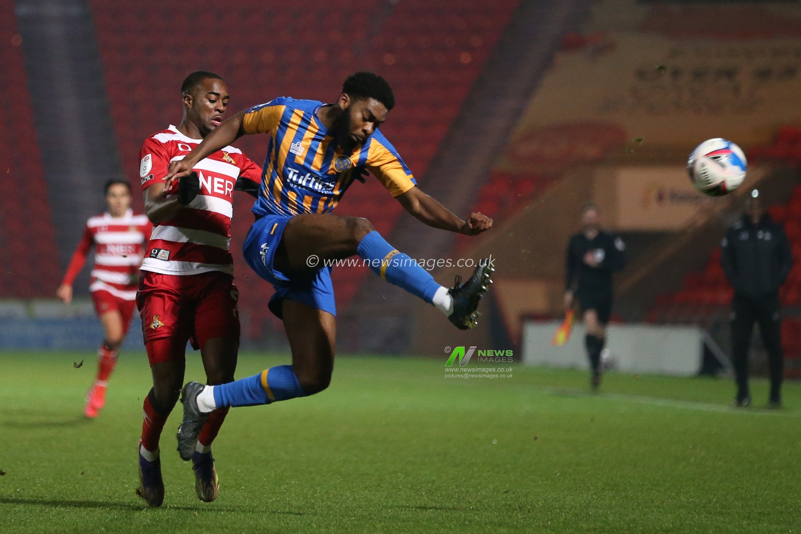 RoShaun Williams #5 of Shrewsbury Town clears away the ball