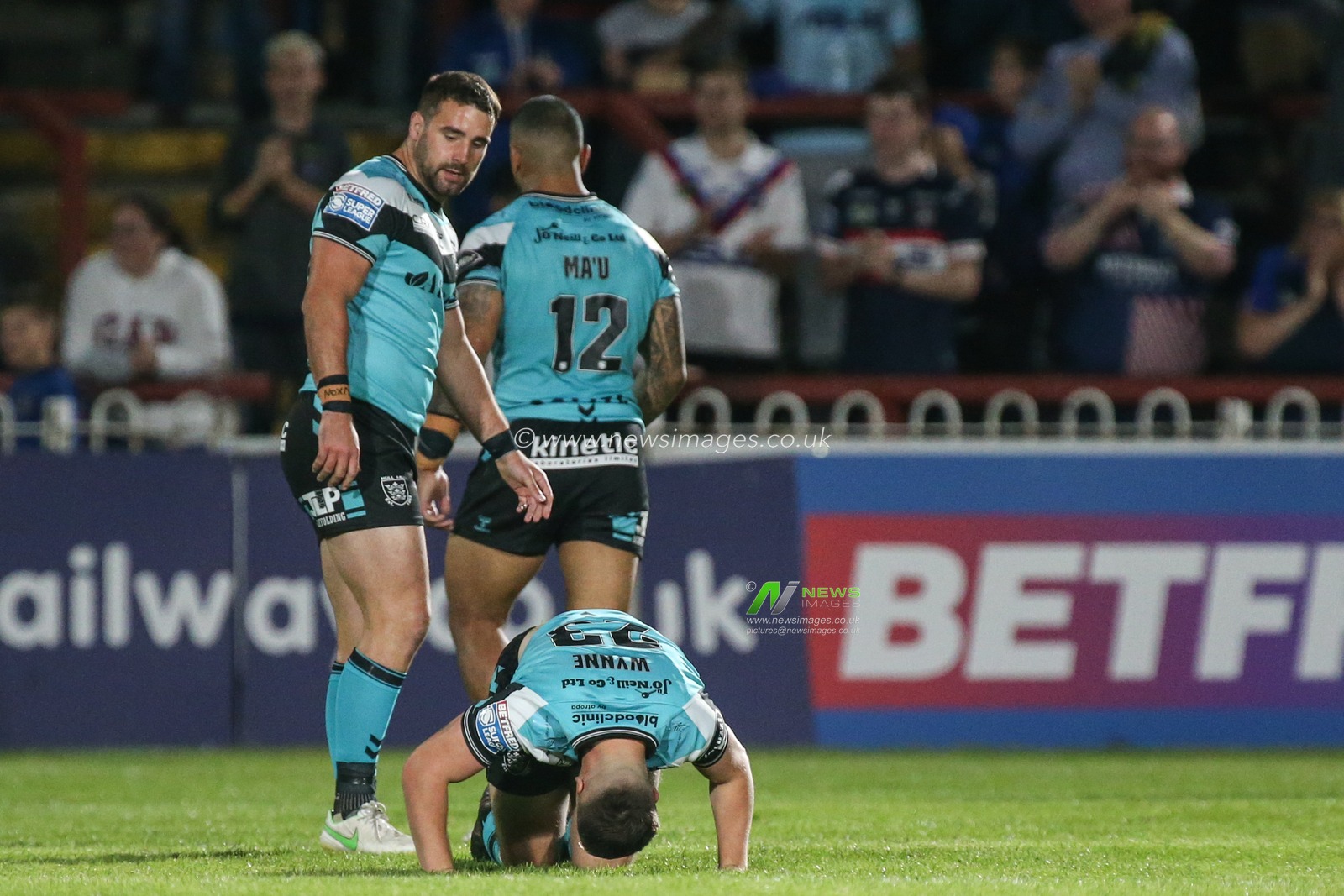 Connor Wynne (23) of Hull FC lies on the ground injured