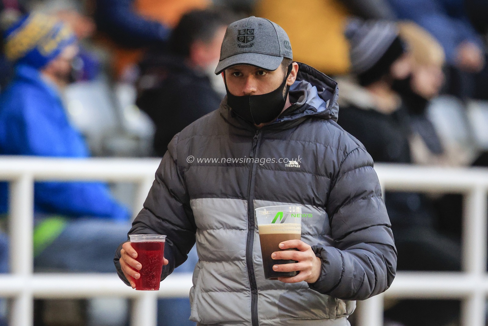 A fan carries two drinks as 1750 people were allowed into Kingston Park Stadium to watch the Gallagher Premiership match between Newcastle Falcons and Northampton Saints