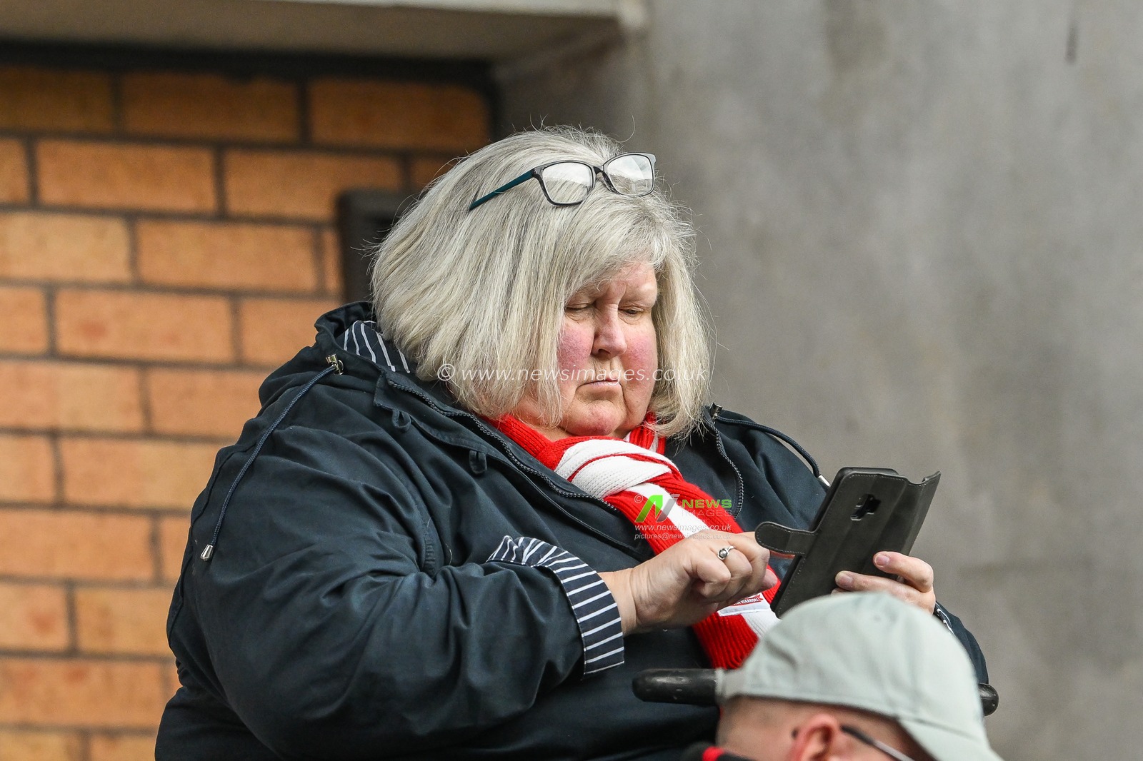 Fans look at there phones as the Uk wide emergency phone message appears on them ahead of the Betfred Super League Round 10 match Wigan Warriors vs Wakefield Trinity at DW Stadium, Wigan, United Kingdom, 23rd April 2023

(Photo by Craig Thomas/News Images)