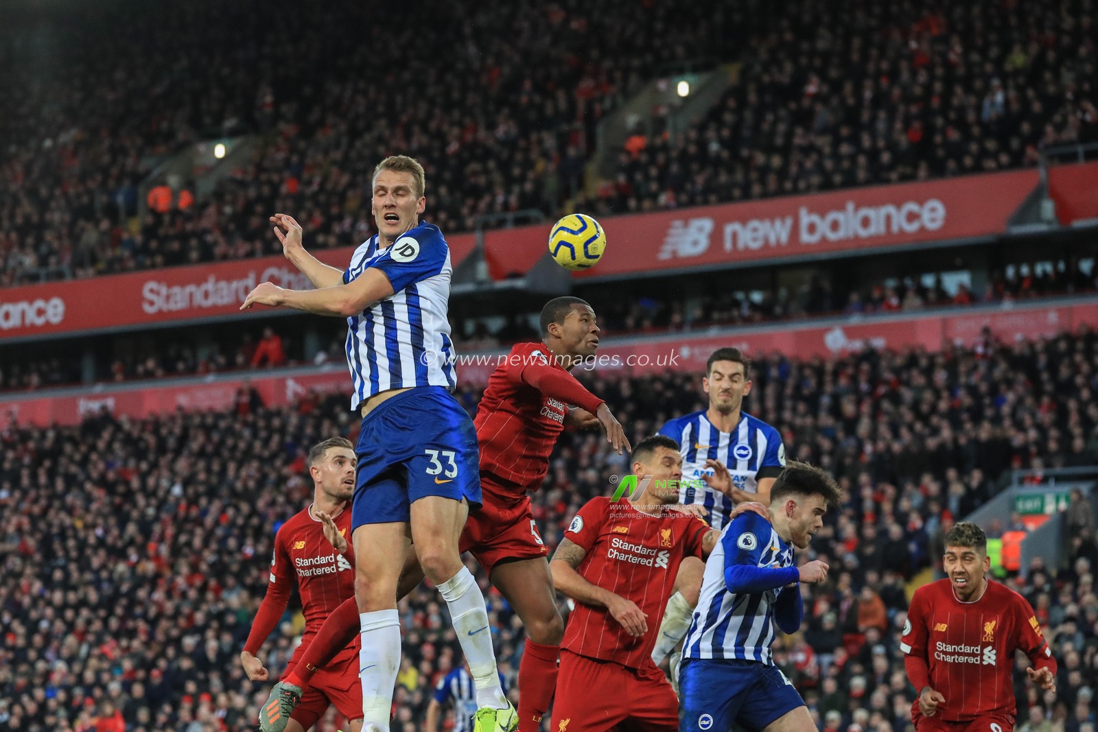30th November 2019, Anfield, Liverpool, England; Premier League, Liverpool v Brighton and Hove Albion : Georginio Wijnaldum (5) of Liverpool heads the ball clear from a corner 

Credit: Mark Cosgrove/News Images