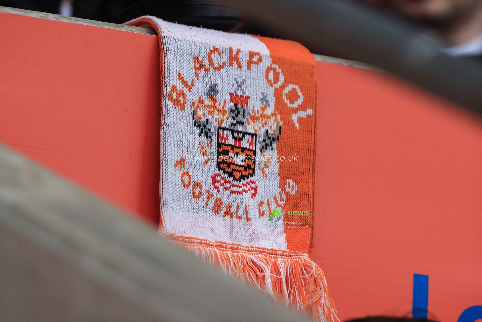A Blackpool scarf laid over a wall