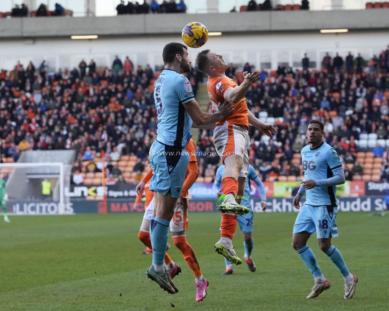 Shayne Lavery of Blackpool competes for a header with Elliott Moore of Oxford United during the Sky Bet League 1 match Blackpool vs Oxford United at Bloomfield Road, Blackpool, United Kingdom, 10th February 2024

(Photo by Steve Flynn/News Images)
