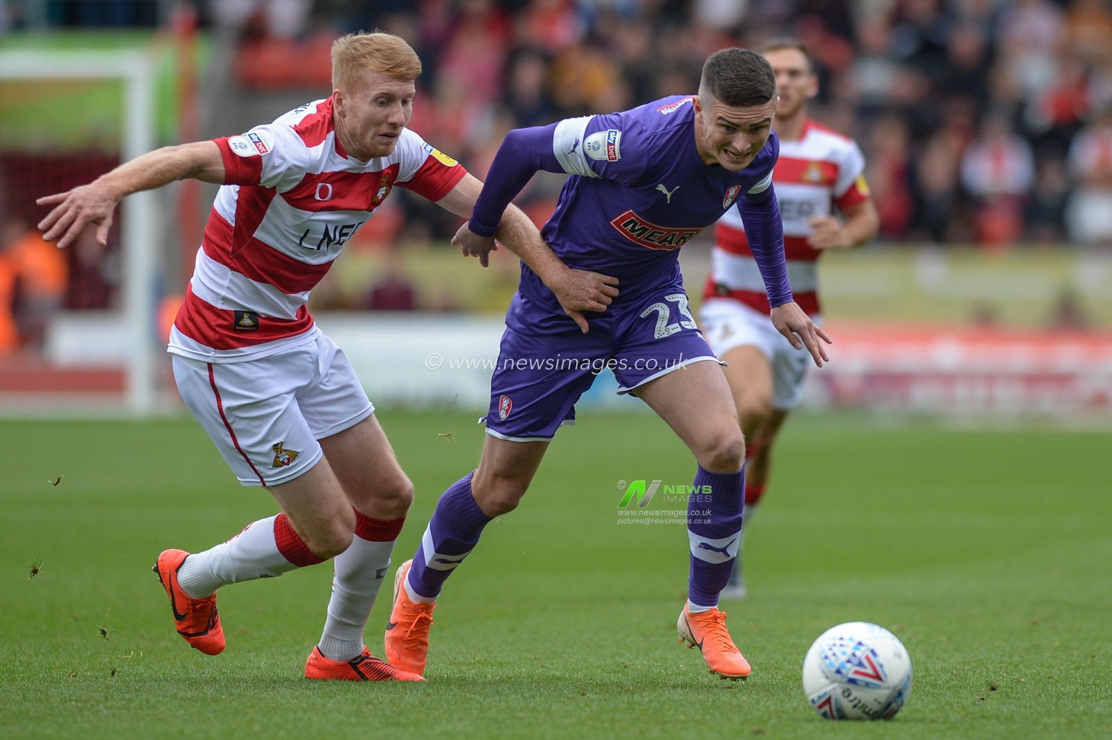 7th September 2019, Keepmoat Stadium, Doncaster, England; Sky Bet League One Football, Doncaster Rovers vs Rotherham United ; Jake Hastie (23) of Rotherham United takes on Brad Halliday (2) of Doncaster Rovers in the local derby match.

Credit: Dean Williams/News Images

English Football League images are subject to DataCo Licence