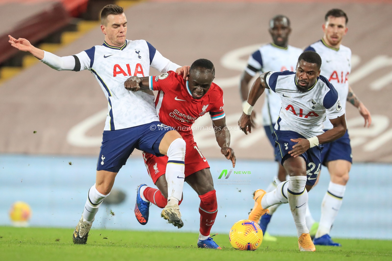 Sadio Mane #10 of Liverpool is caught by Giovani Lo Celso #18 of Tottenham Hotspur