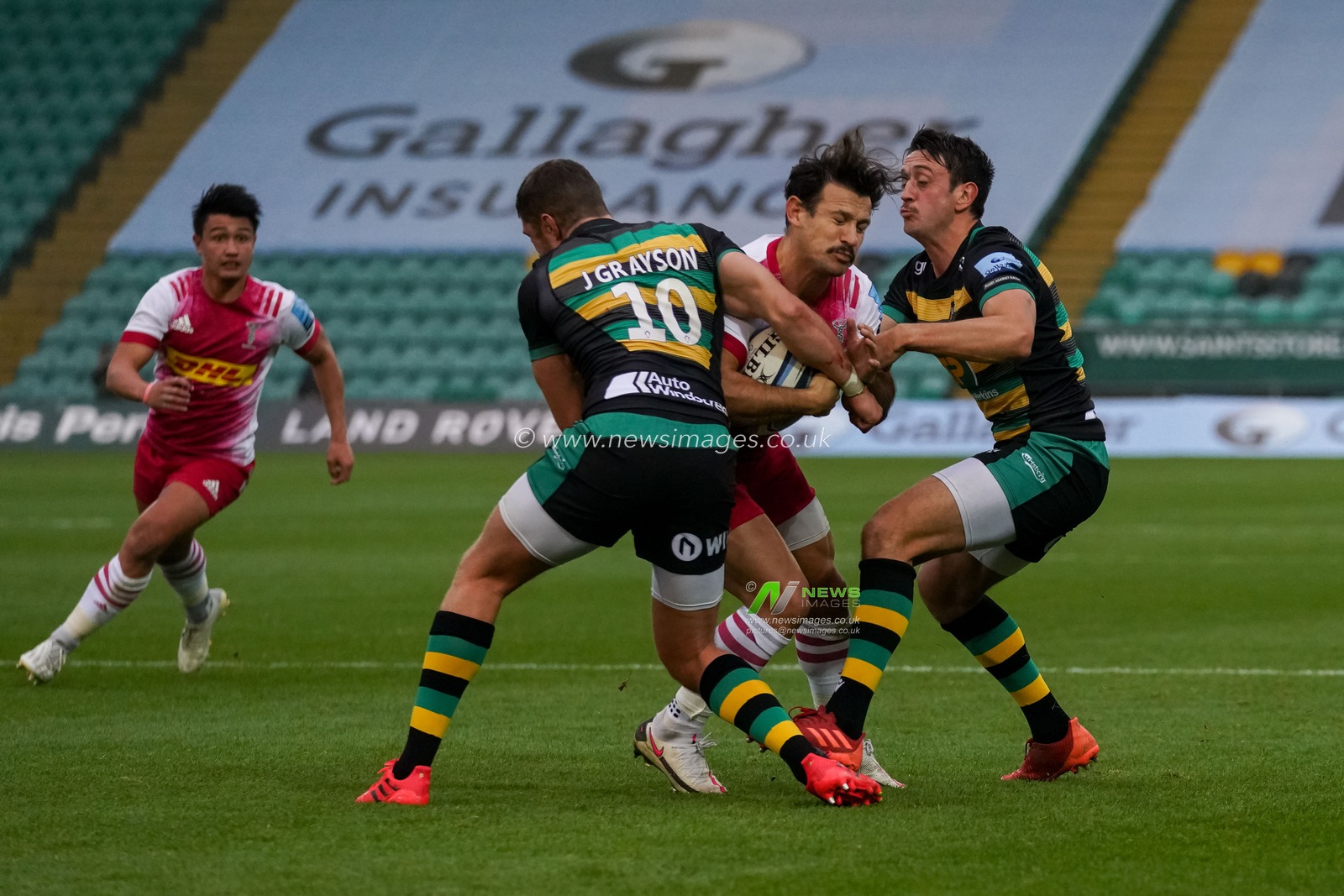 Alex Mitchell #9 of Northampton Saints and James Grayson #10 of Northampton Saints battles with Danny Care #9 of Harlequins
