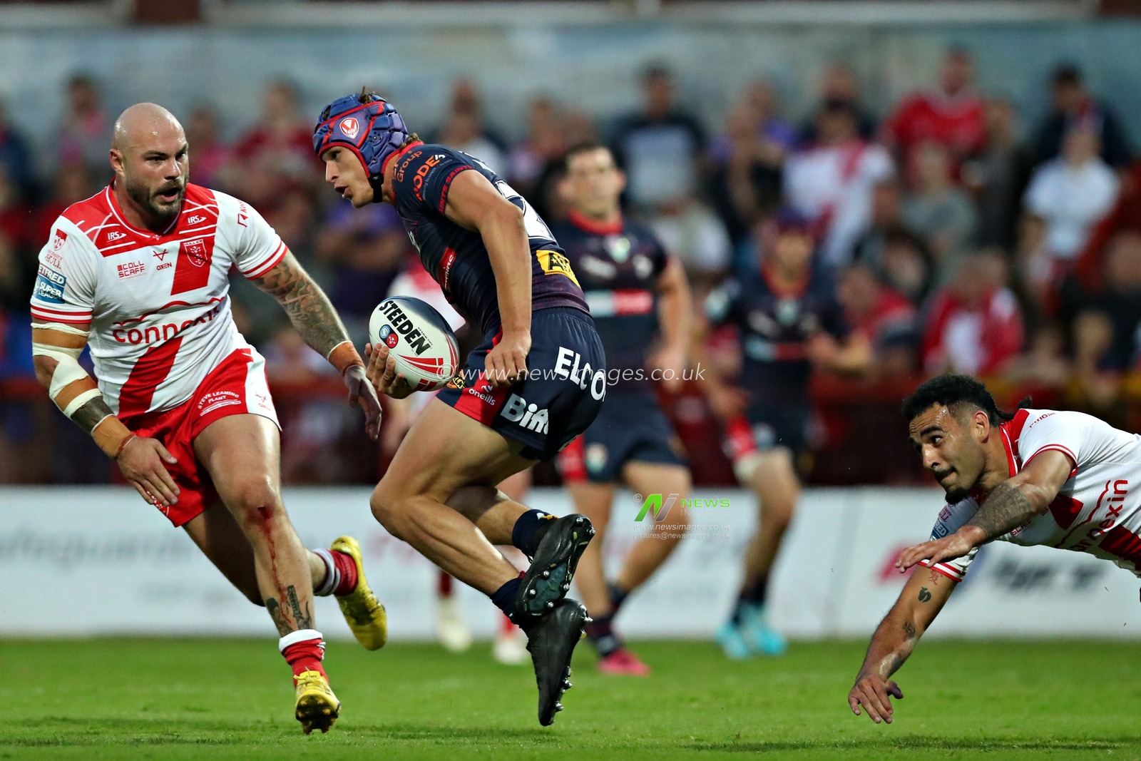 Sam Luckley and Tyrone May of Hull KR pressure Harry Robertson of St. Helens during the Betfred Super League Round 13 match Hull KR vs St Helens at Sewell Group Craven Park, Kingston upon Hull, United Kingdom, 30th May 2025(Photo by Sam Eaden/News Images)
