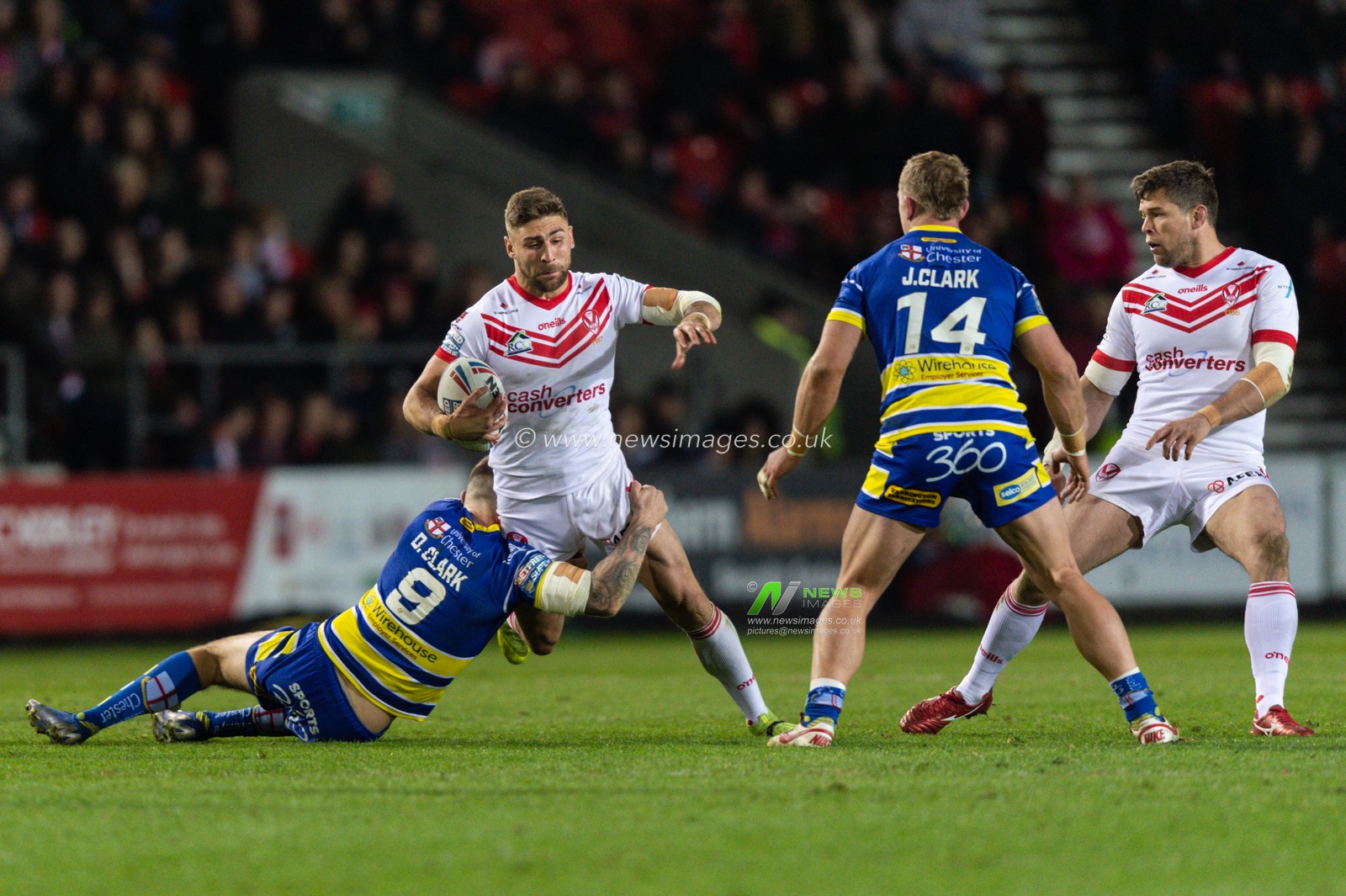 12th April 2019 , Totally Wicked Stadium, St Helens, England;  Betfred Super League, Round 10, St Helens vs Warrington Wolves,  Tommy Makinson of St Helens is tackled by Daryl Clark of Warrington Wolves 

Credit: Richard Long/News Images