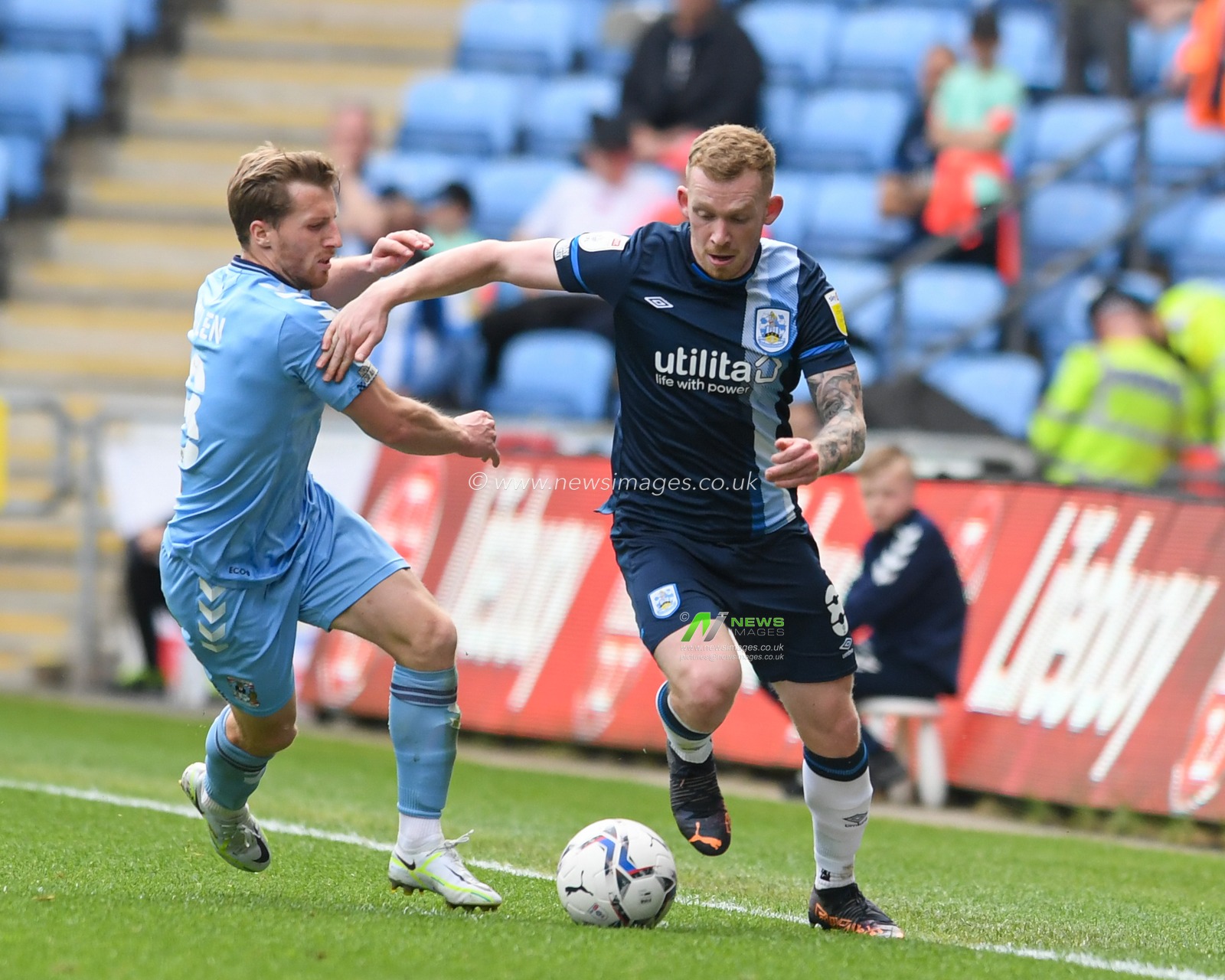 Lewis O'Brien #8 of Huddersfield Town runs down the wing with the ball