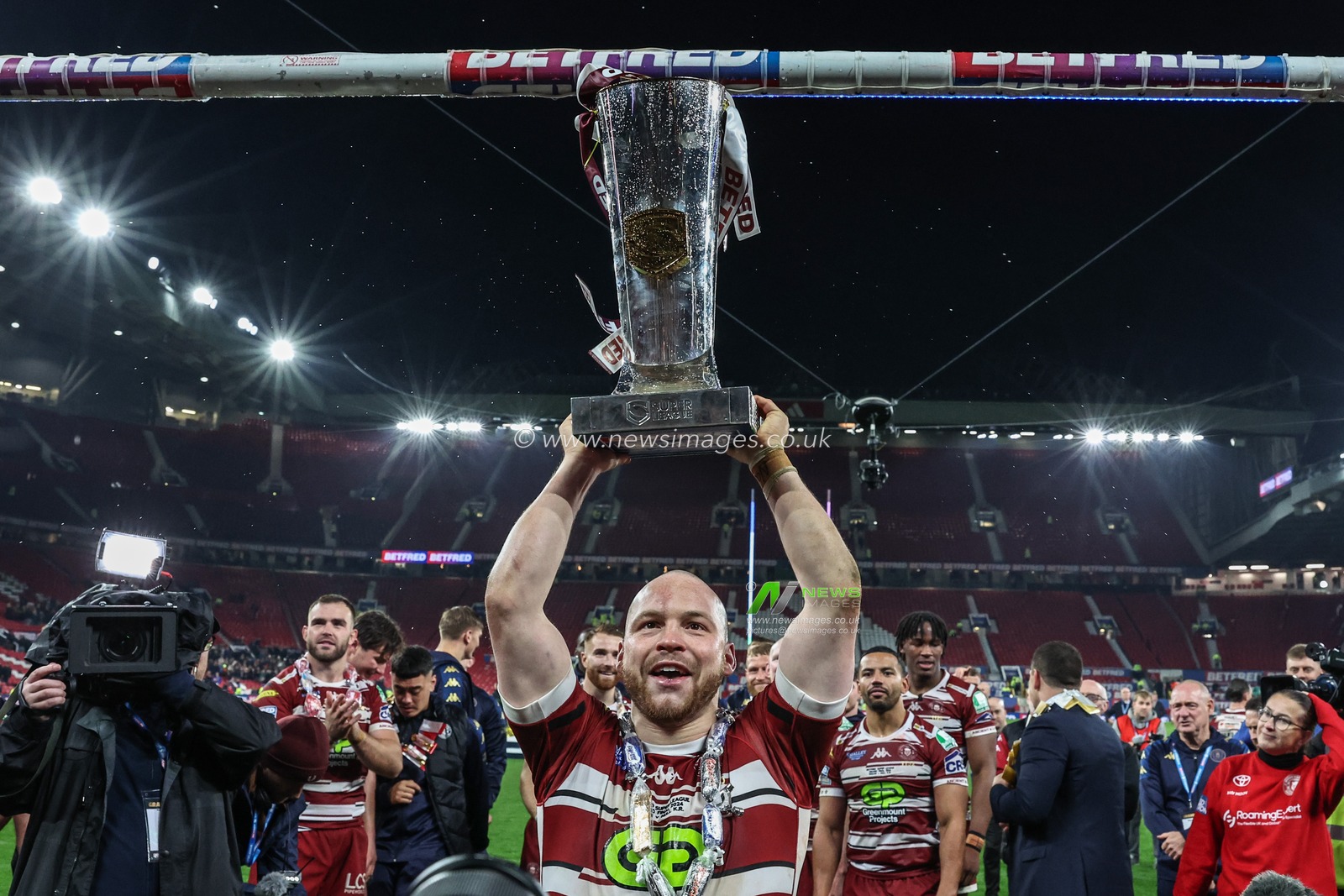 Liam Marshall of Wigan Warriors lifts the Betfred Super League Grand Final trophy during the Betfred Super League Grand Final match Wigan Warriors vs Hull KR at Old Trafford, Manchester, United Kingdom, 12th October 2024

(Photo by Mark Cosgrove/News Images)