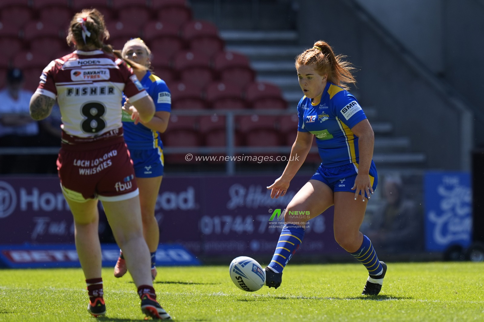 Caitlin Casey of Leeds Rhinos chips the ball through the Wigan Warriors defence during the Betfred Women's Challenge Cup Semi-Final match Leeds Rhinos vs Wigan Warriors at Totally Wicked Stadium, St Helens, United Kingdom, 19th May 2024

(Photo by Steve Flynn/News Images)